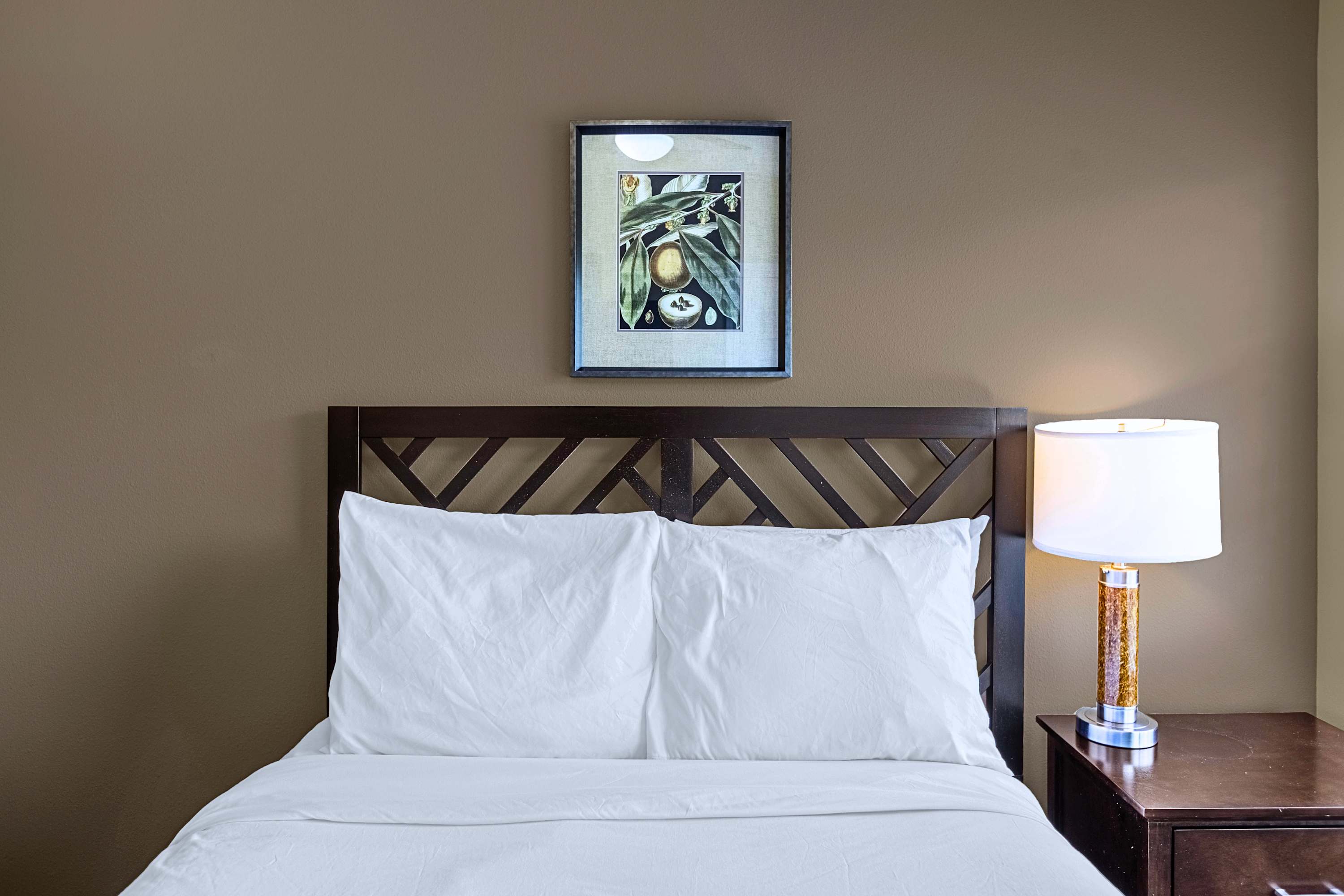 A peaceful bedroom retreat dressed in crisp white linens and neutral decor