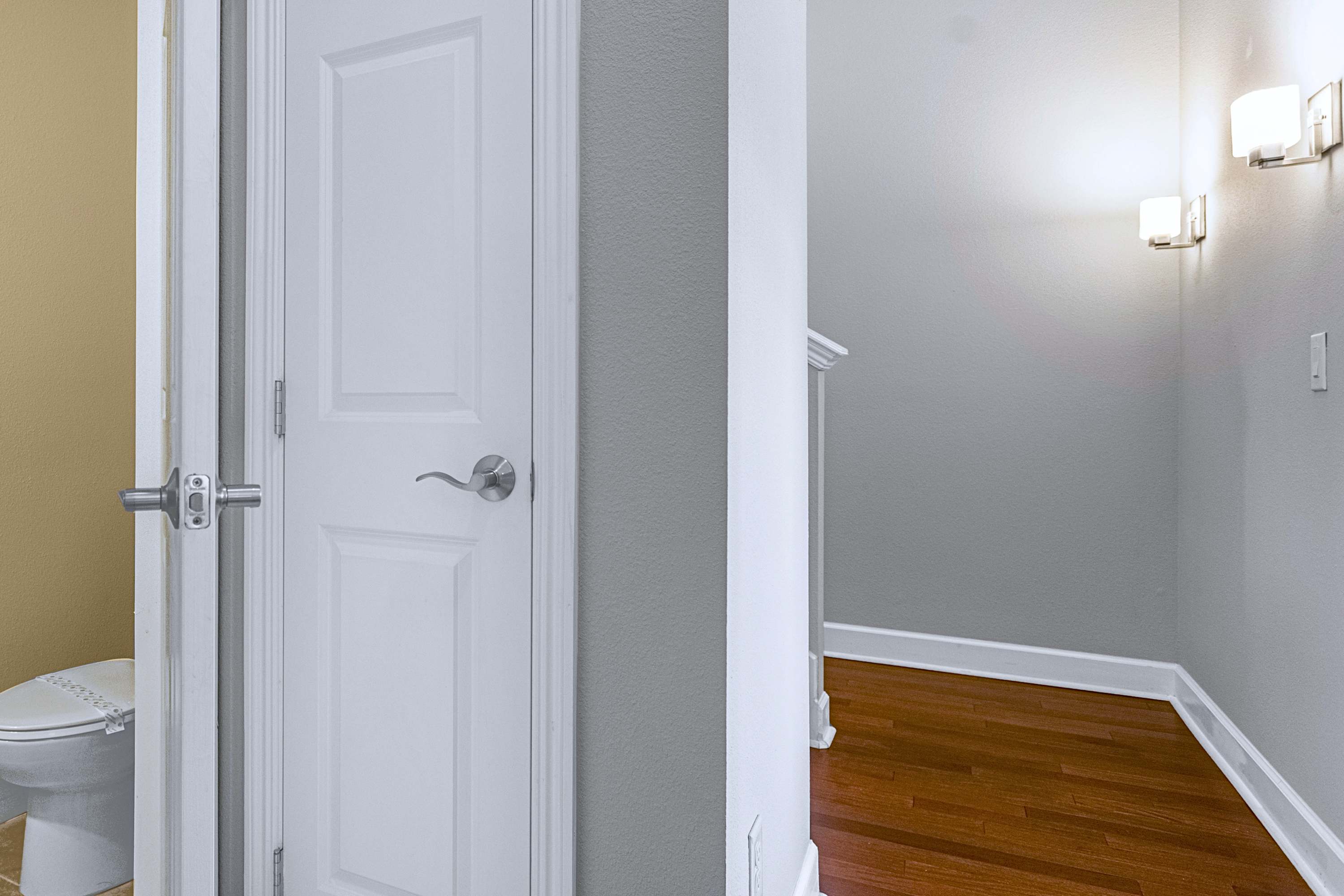 A clean interior hallway leading upstairs to private bedroom quarters