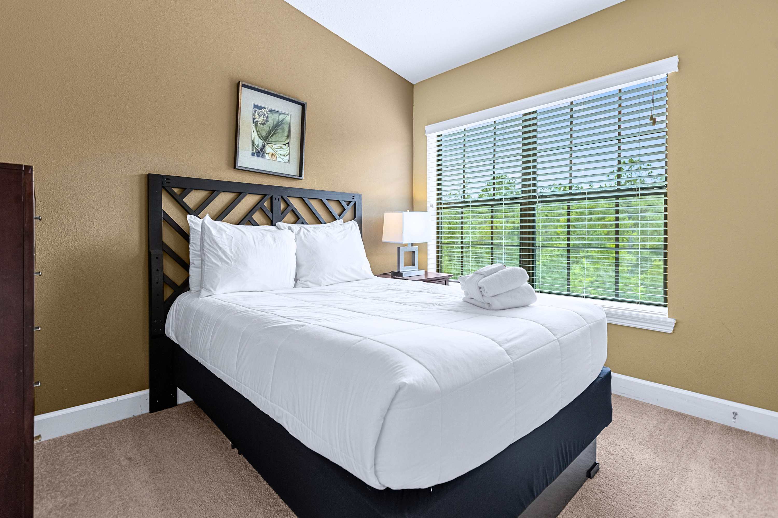 Inviting bedroom setup featuring comfortable bedding and natural sunlight