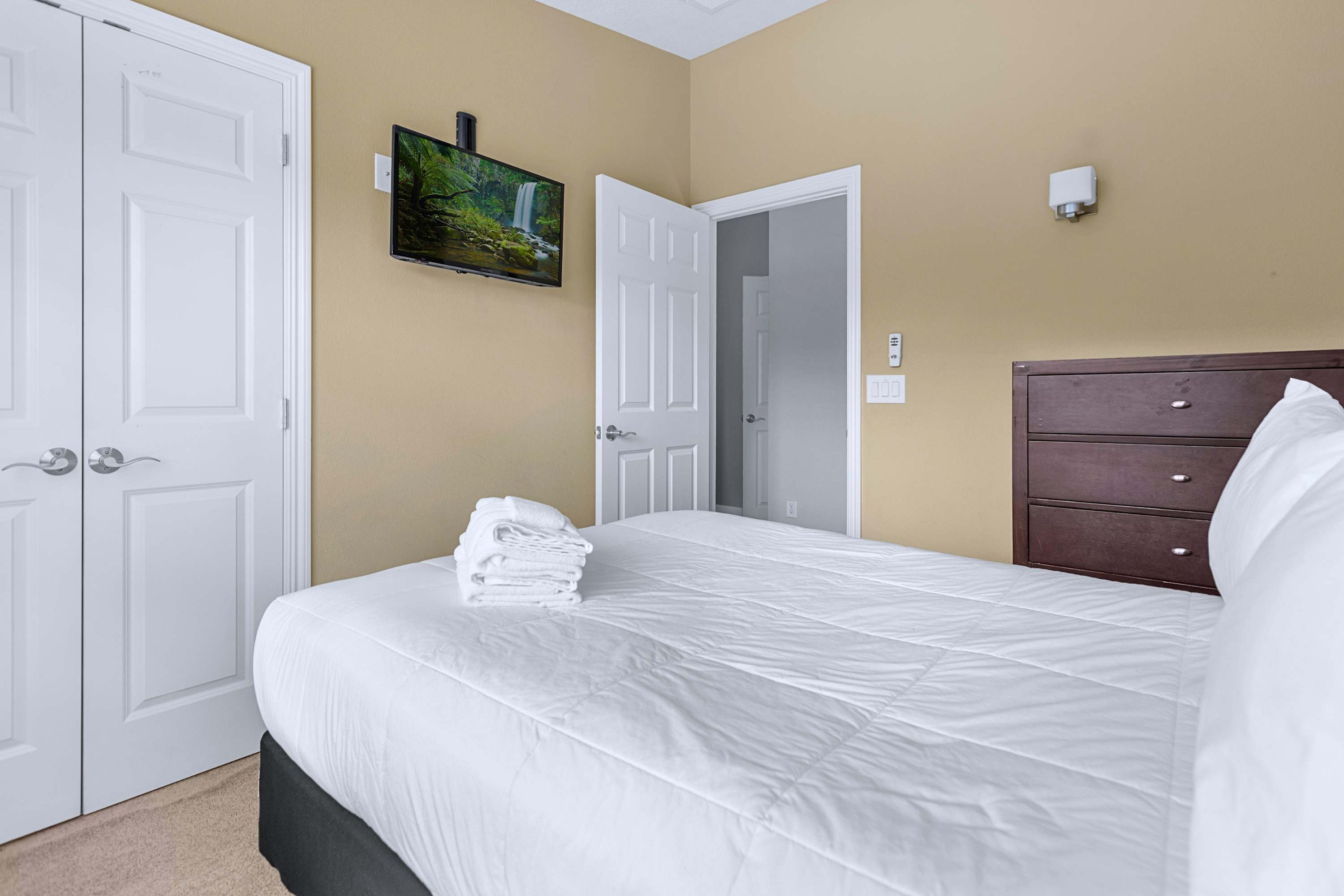 Comfortable guest suite featuring a wall-mounted TV for private entertainment