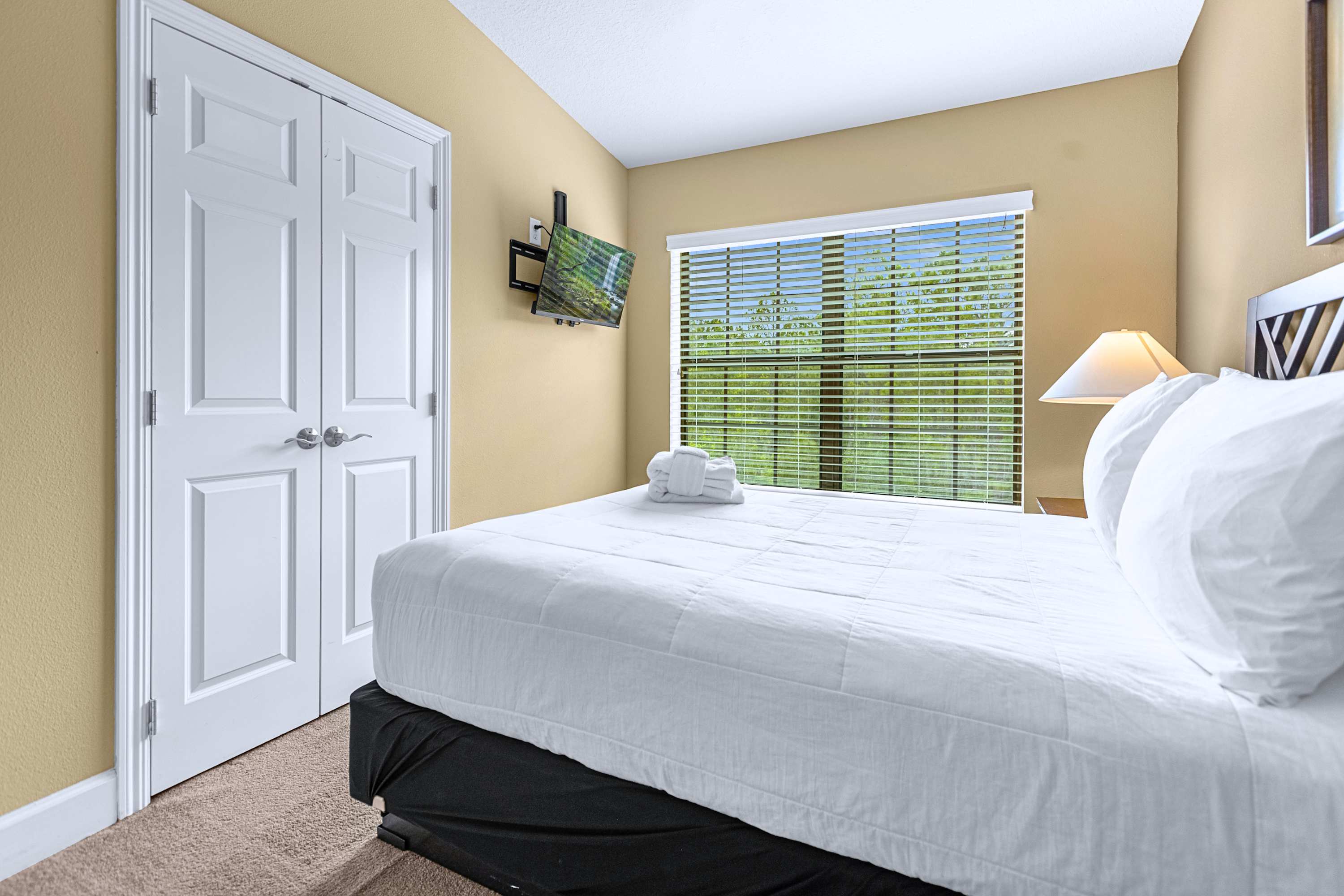A calm guest bedroom styled with minimal decor and crisp white linens
