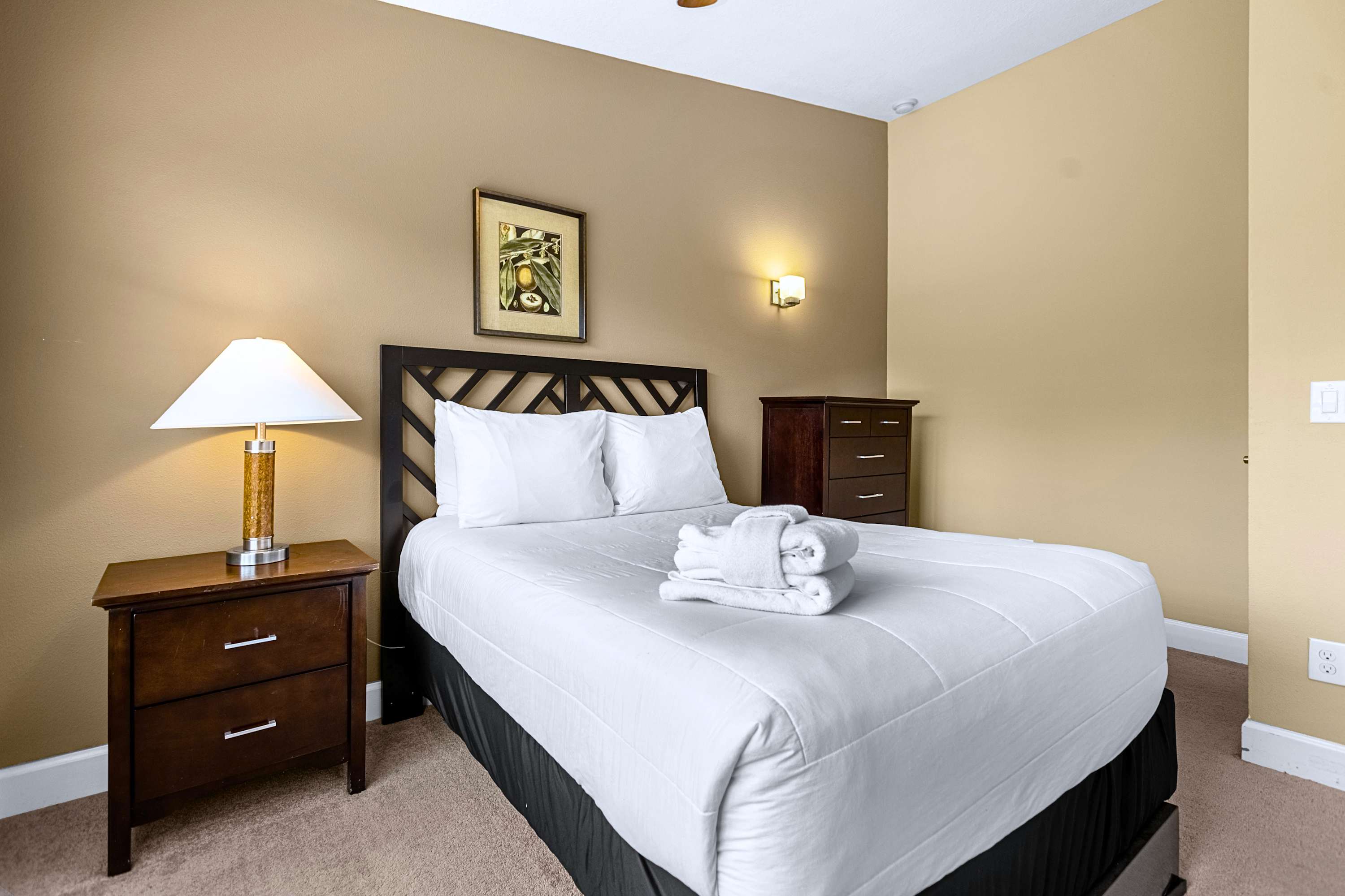 A peaceful bedroom retreat dressed in crisp white linens and neutral decor