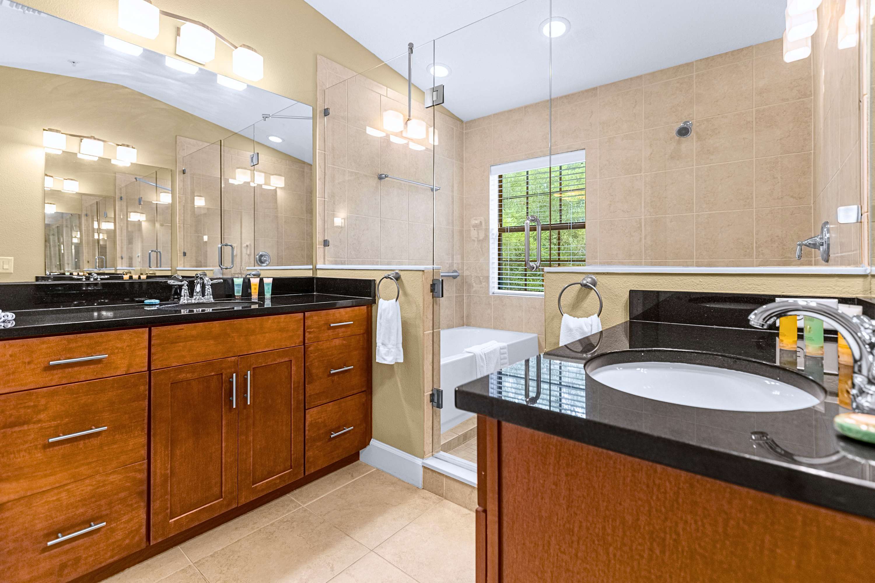 Spacious bathroom suite featuring a double vanity with ample lighting