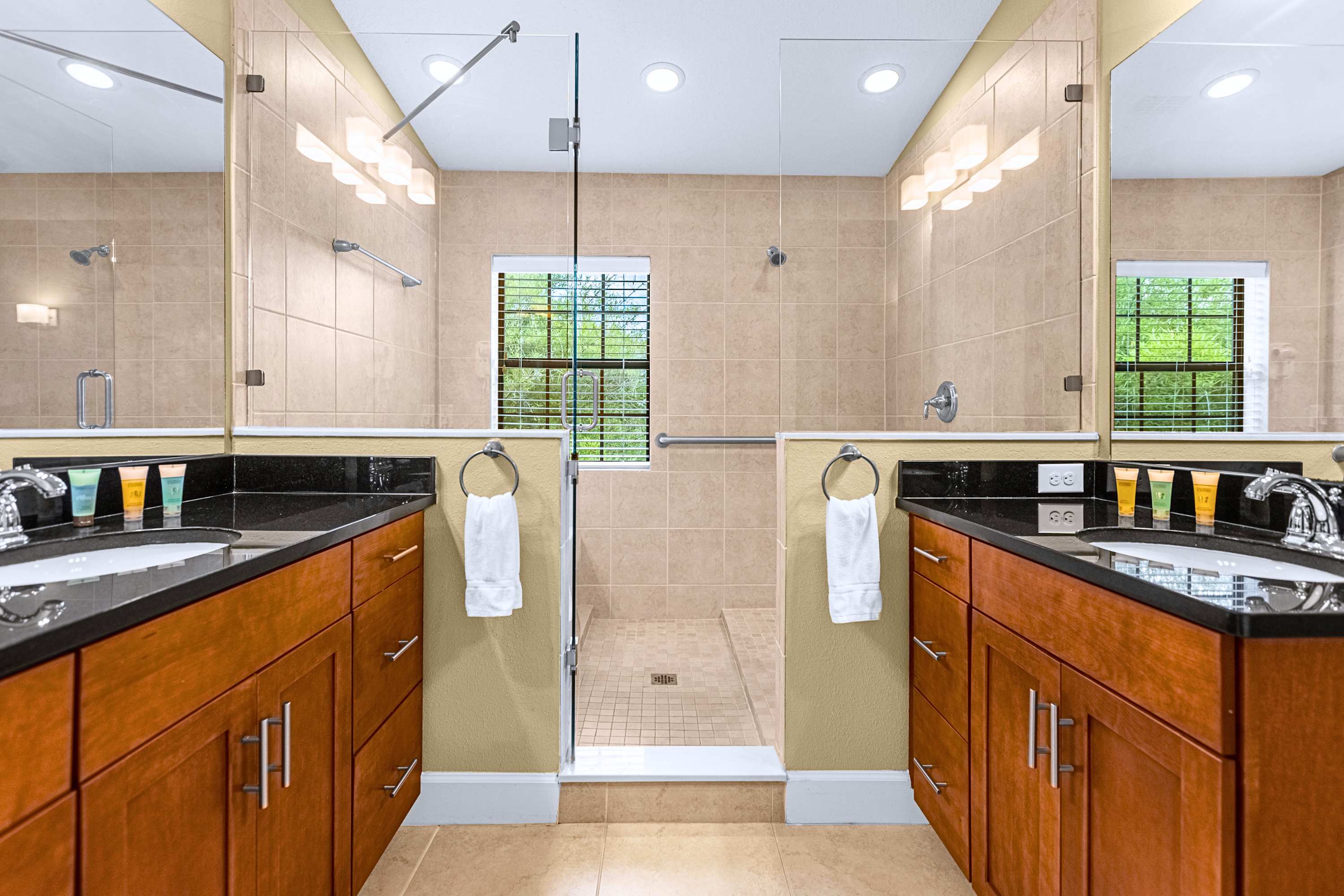 A sleek en-suite bathroom showcasing modern tile finishes and glass doors
