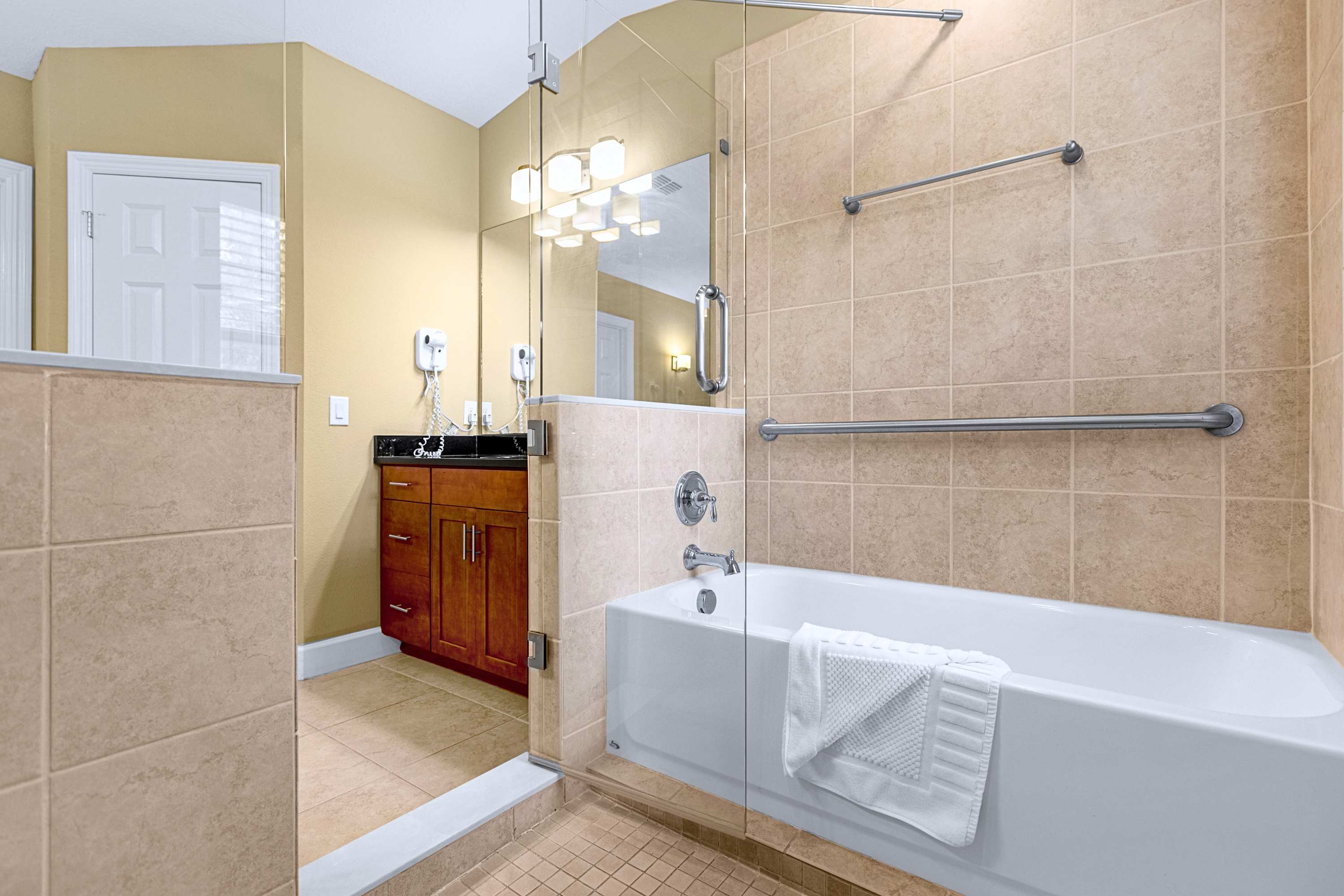 A luxurious bathroom layout complete with a deep soaking tub and tile finish