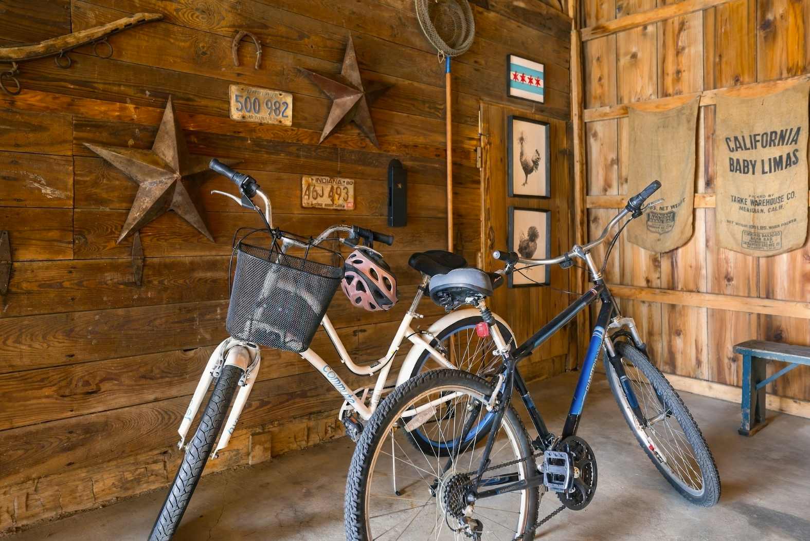 Two bikes with a basket and helmet for exploring Harbor Country roads.