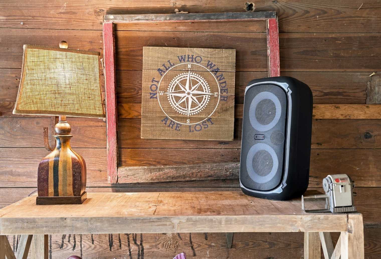 Rustic barn console with lamp and portable speaker for music on game nights.