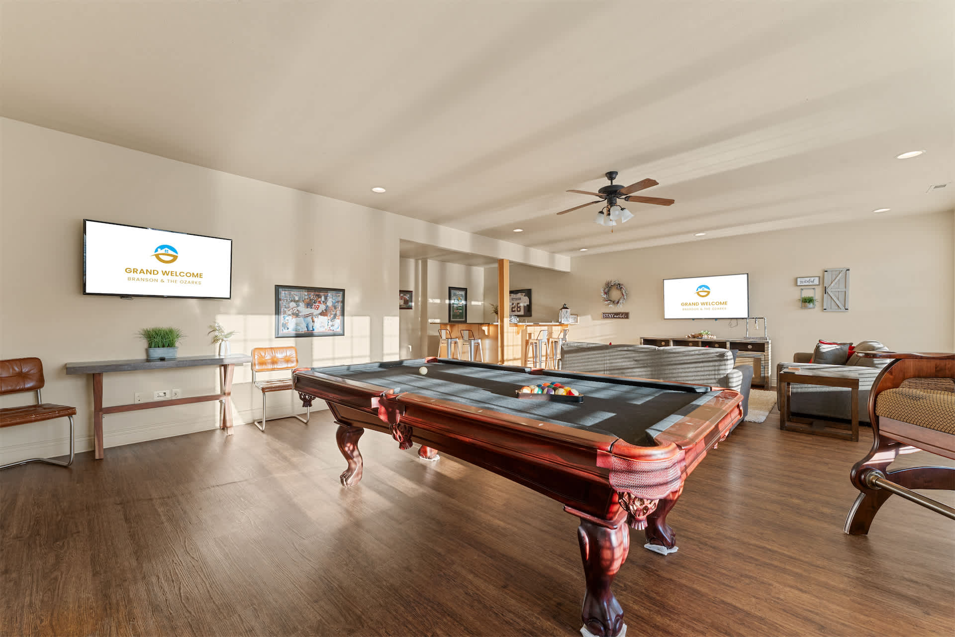 Gather for games and relaxation in the basement, featuring a pool table, comfortable seating, and bar area