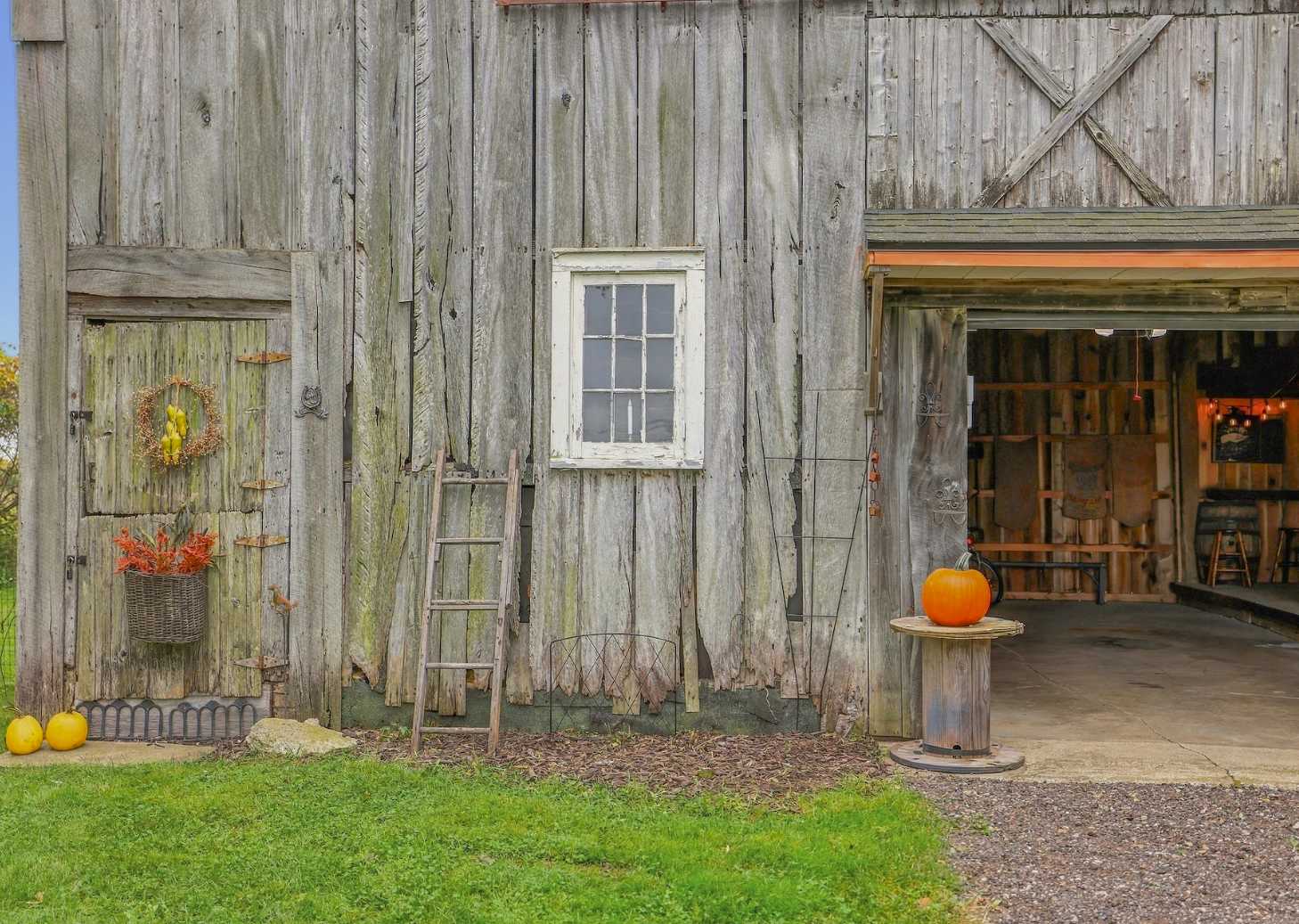 Weathered barn siding and fall pumpkins at a Harbor Country farmhouse.