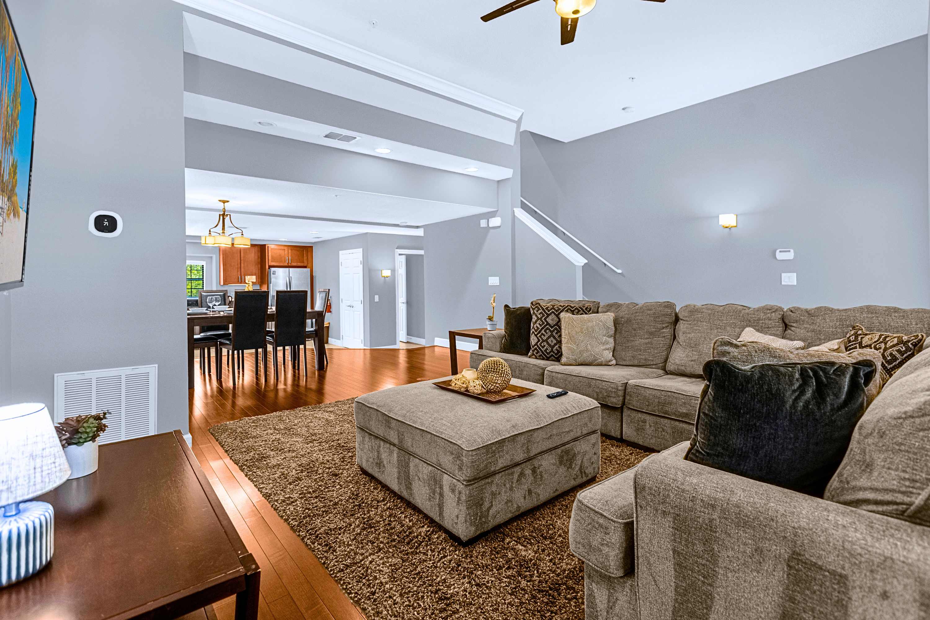 A bright and open living area featuring high ceilings and comfortable seating