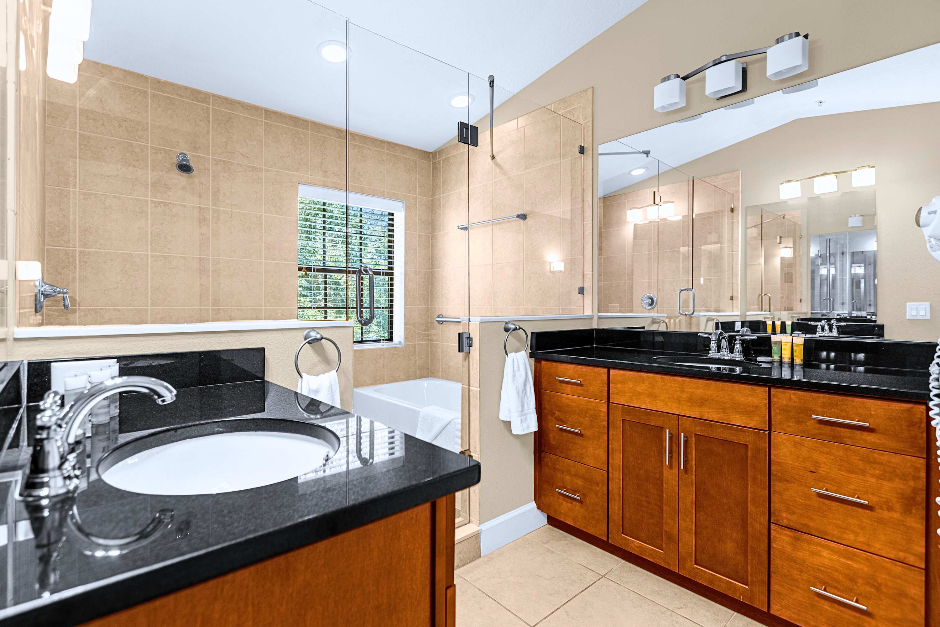 Spacious bathroom suite featuring a double vanity with ample lighting