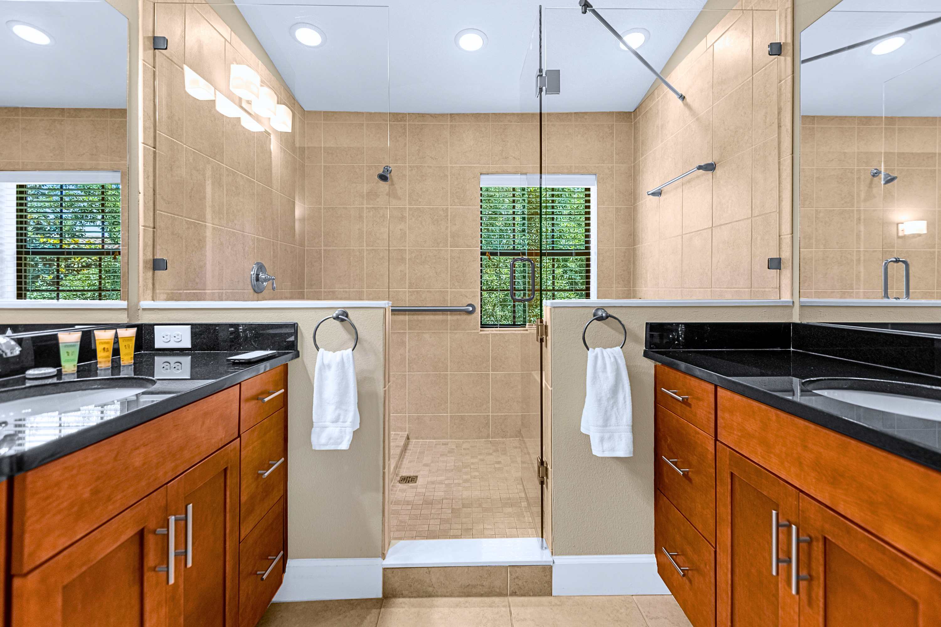 A sleek en-suite bathroom showcasing modern tile finishes and glass doors