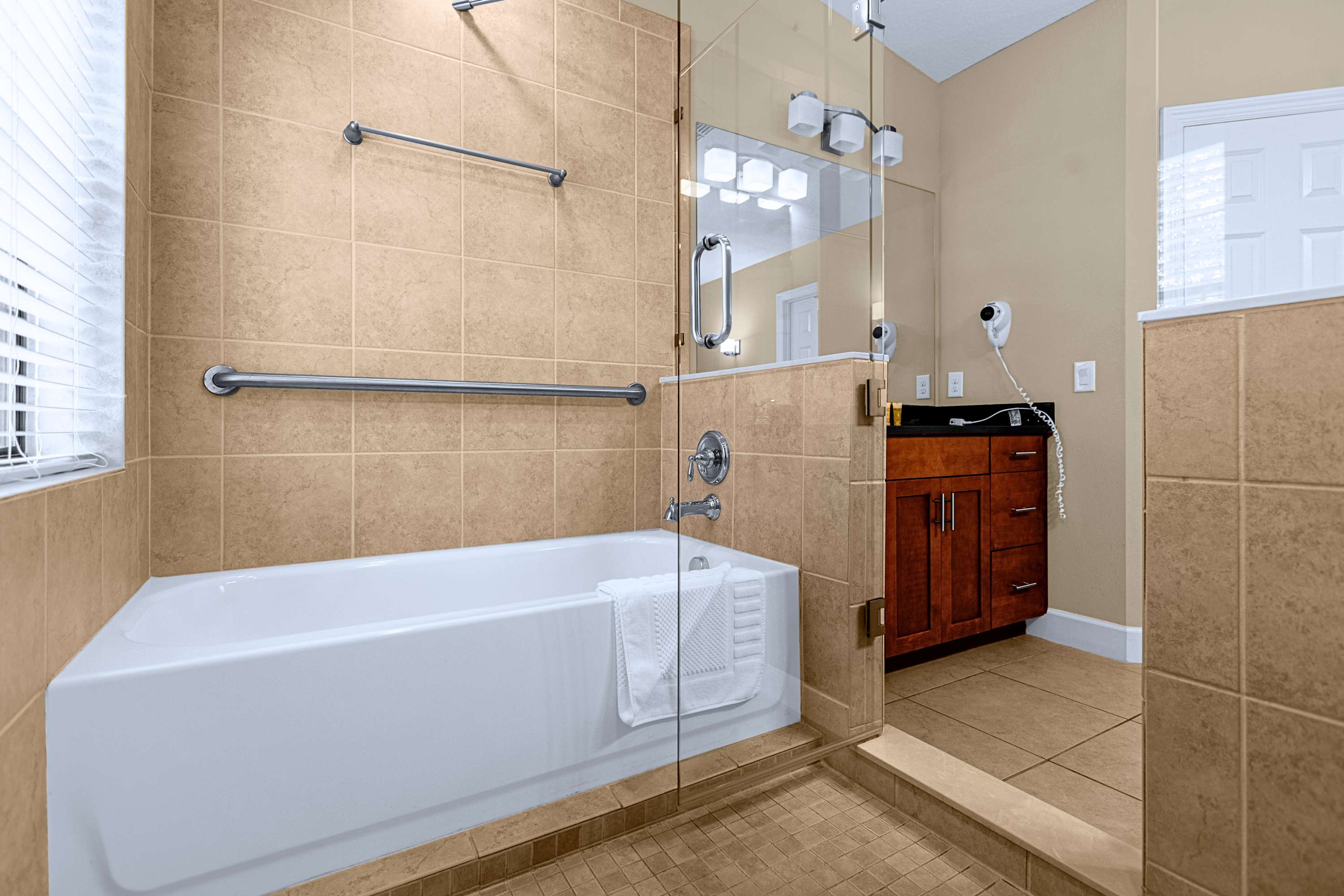 A luxurious bathroom layout complete with a deep soaking tub and tile finish