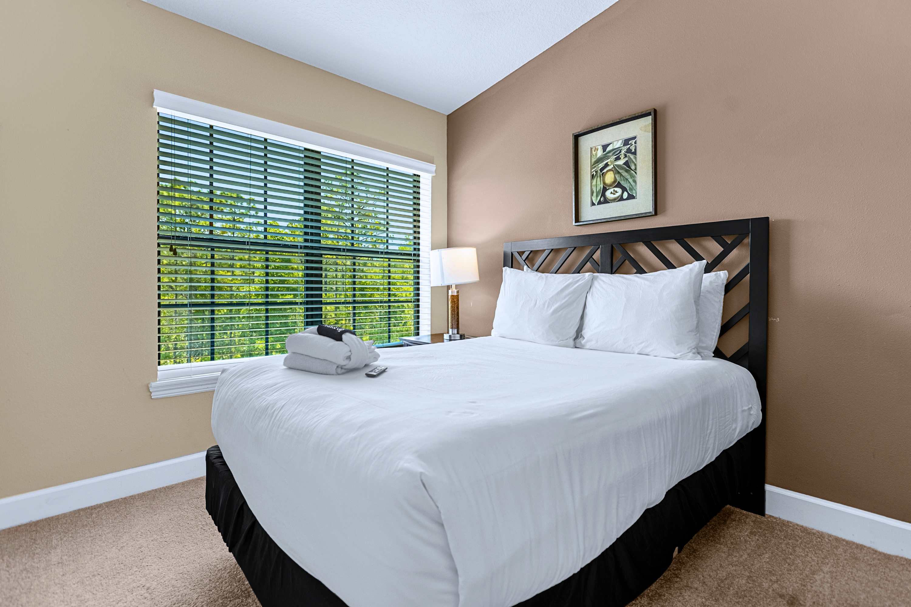 Restful guest room featuring a plush mattress and warm bedside lighting