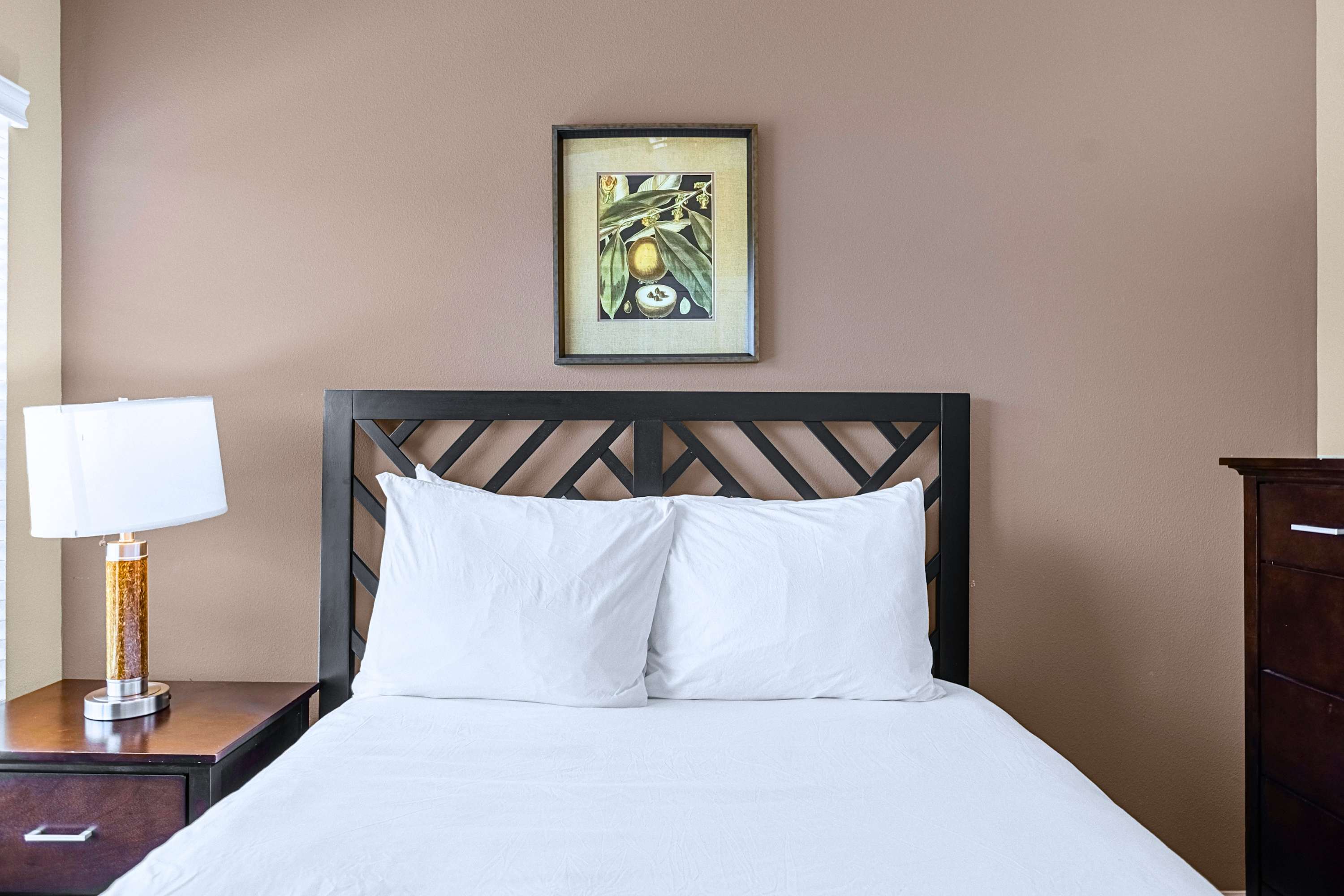 A peaceful bedroom retreat dressed in crisp white linens and neutral decor
