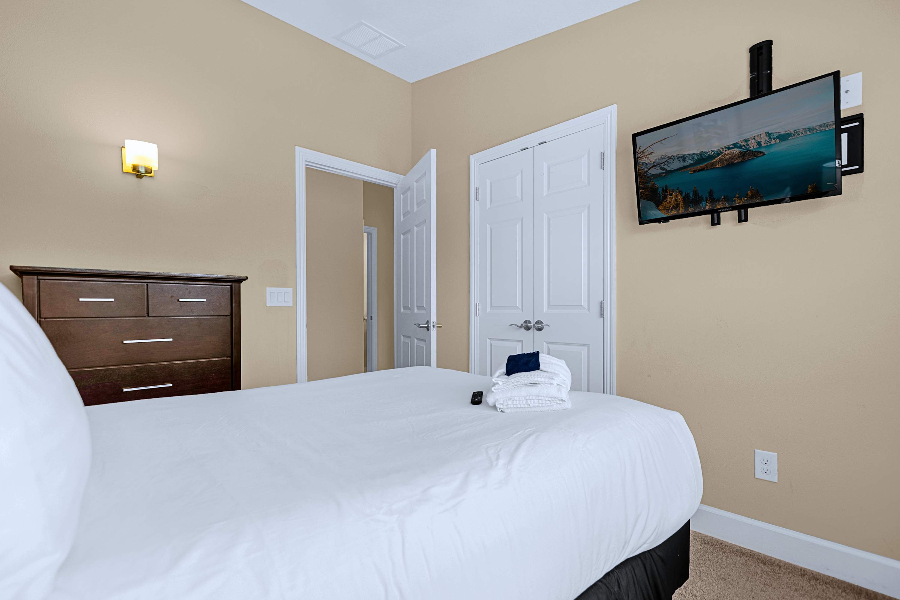 Comfortable guest suite featuring a wall-mounted TV for private entertainment