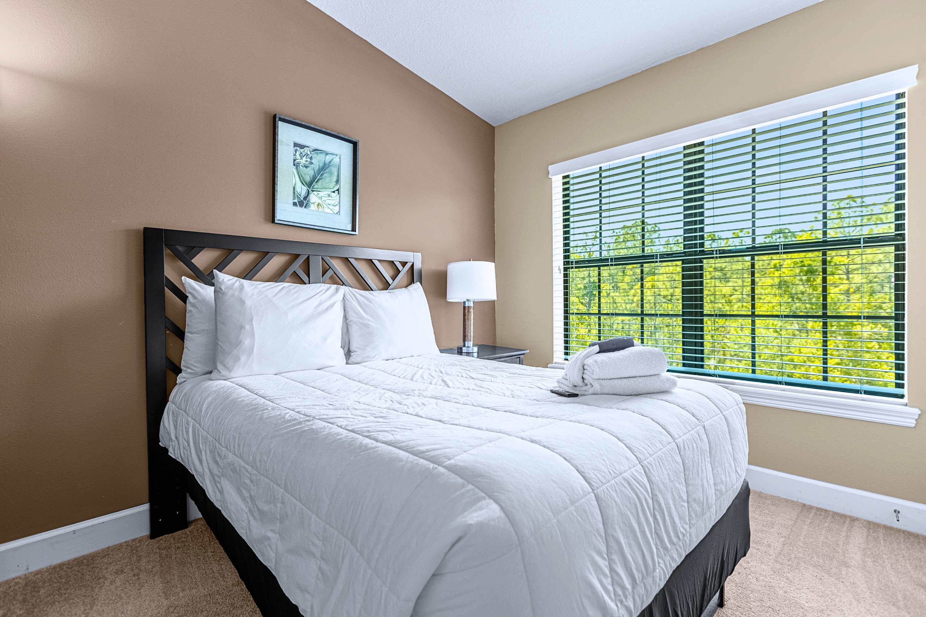 Inviting bedroom setup featuring comfortable bedding and natural sunlight