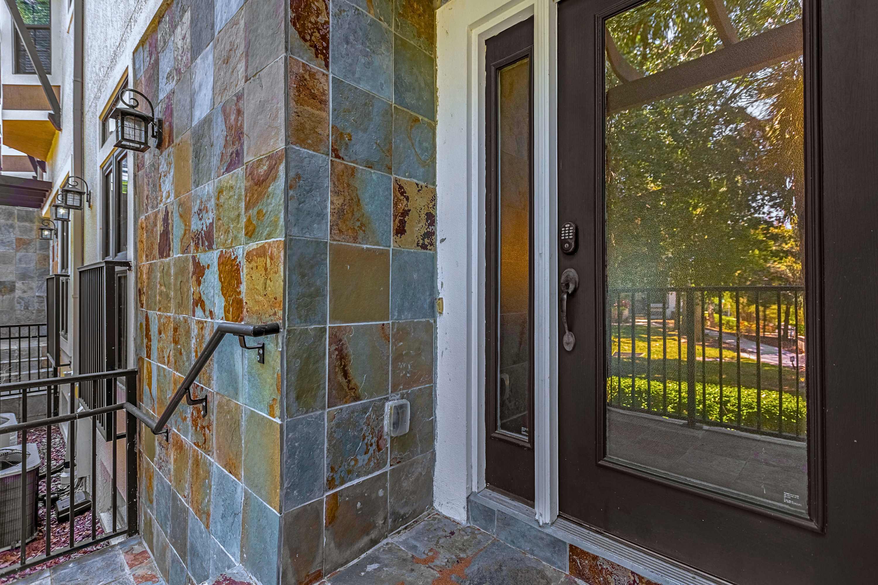 A welcoming front entry door framed by durable stonework accents