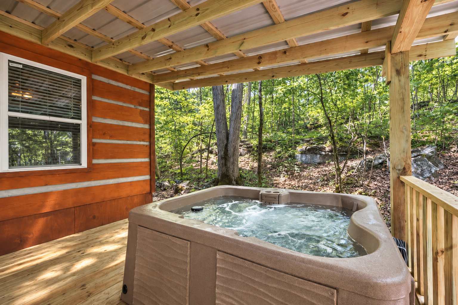 Welcome to Timber Creek Lodge! Enjoy the sheltered hot tub with the forest nearby