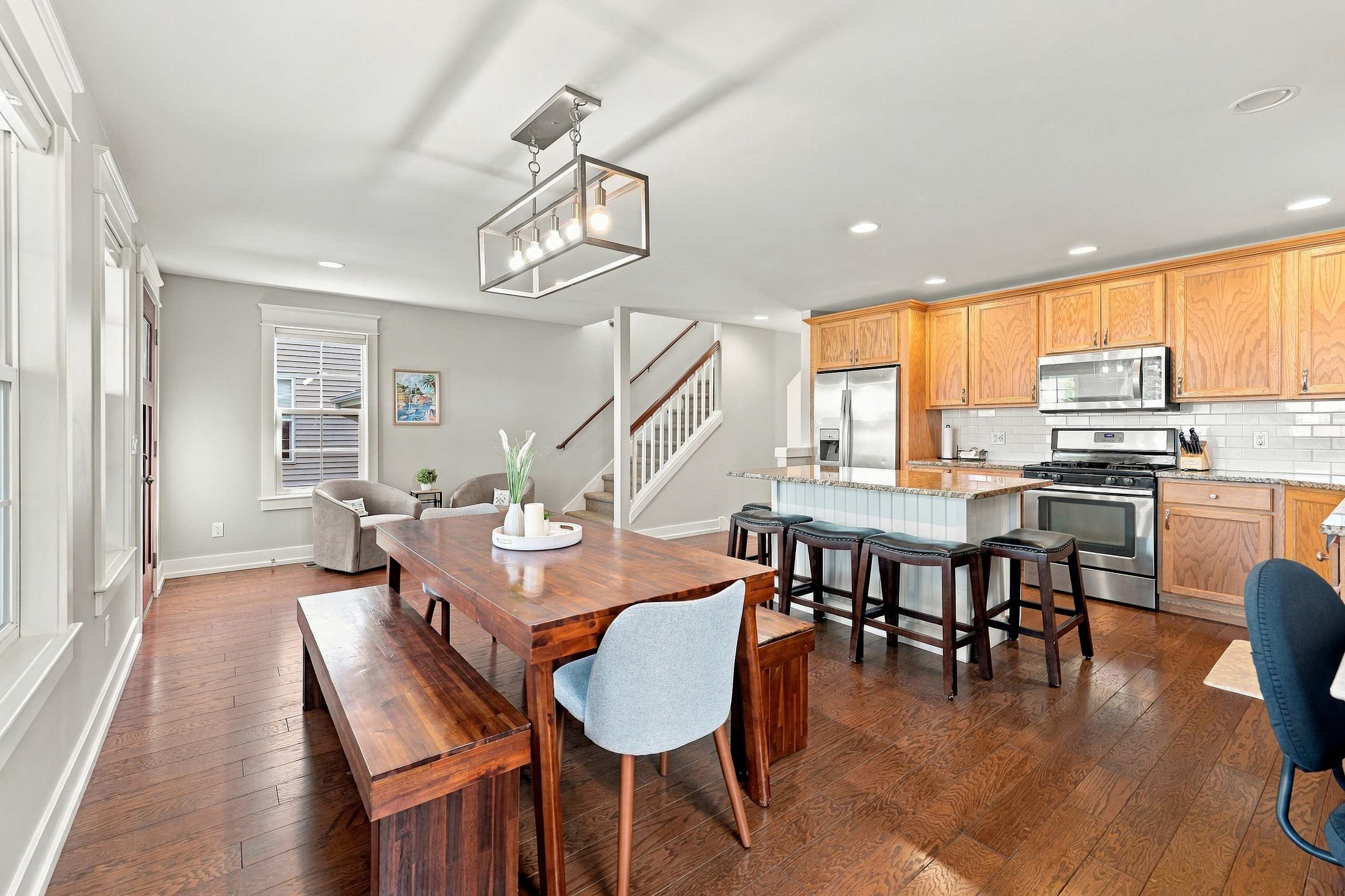 Dining flows to a cozy sitting nook and the stairs to the bedrooms above.