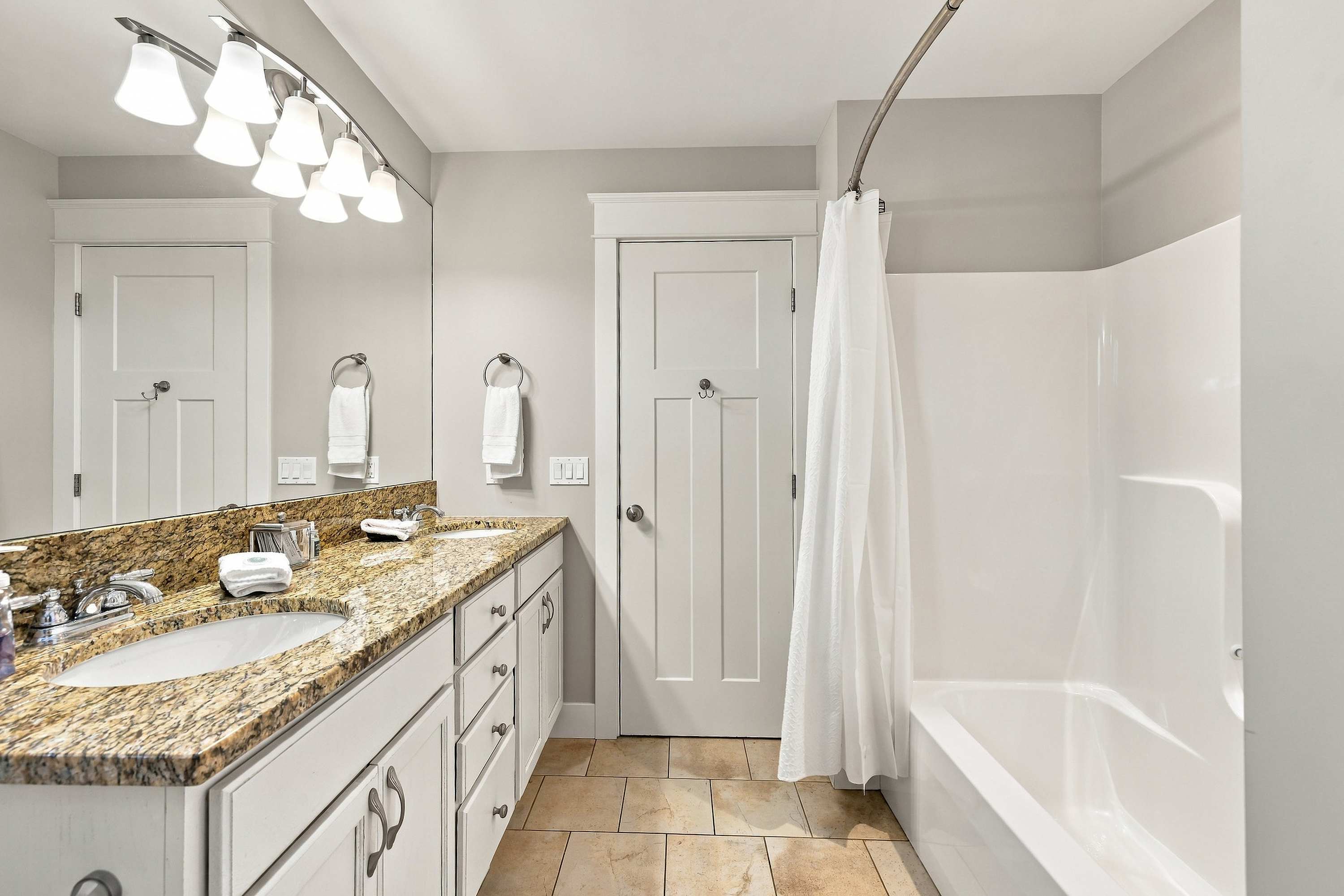 Fresh towels and guest toiletries wait in the shared upstairs bathroom.