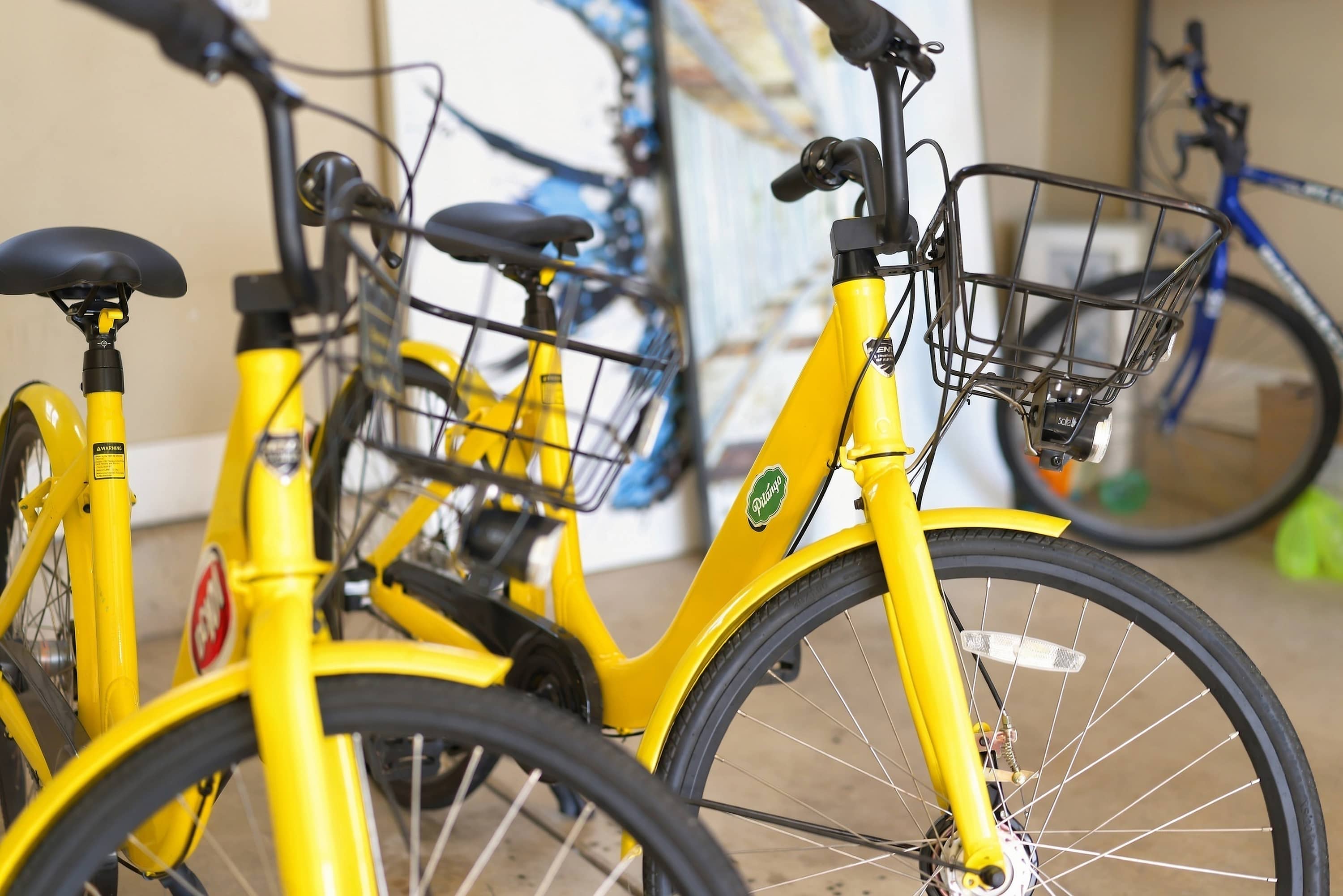 Two yellow bikes with baskets for easy rides around Benton Harbor.