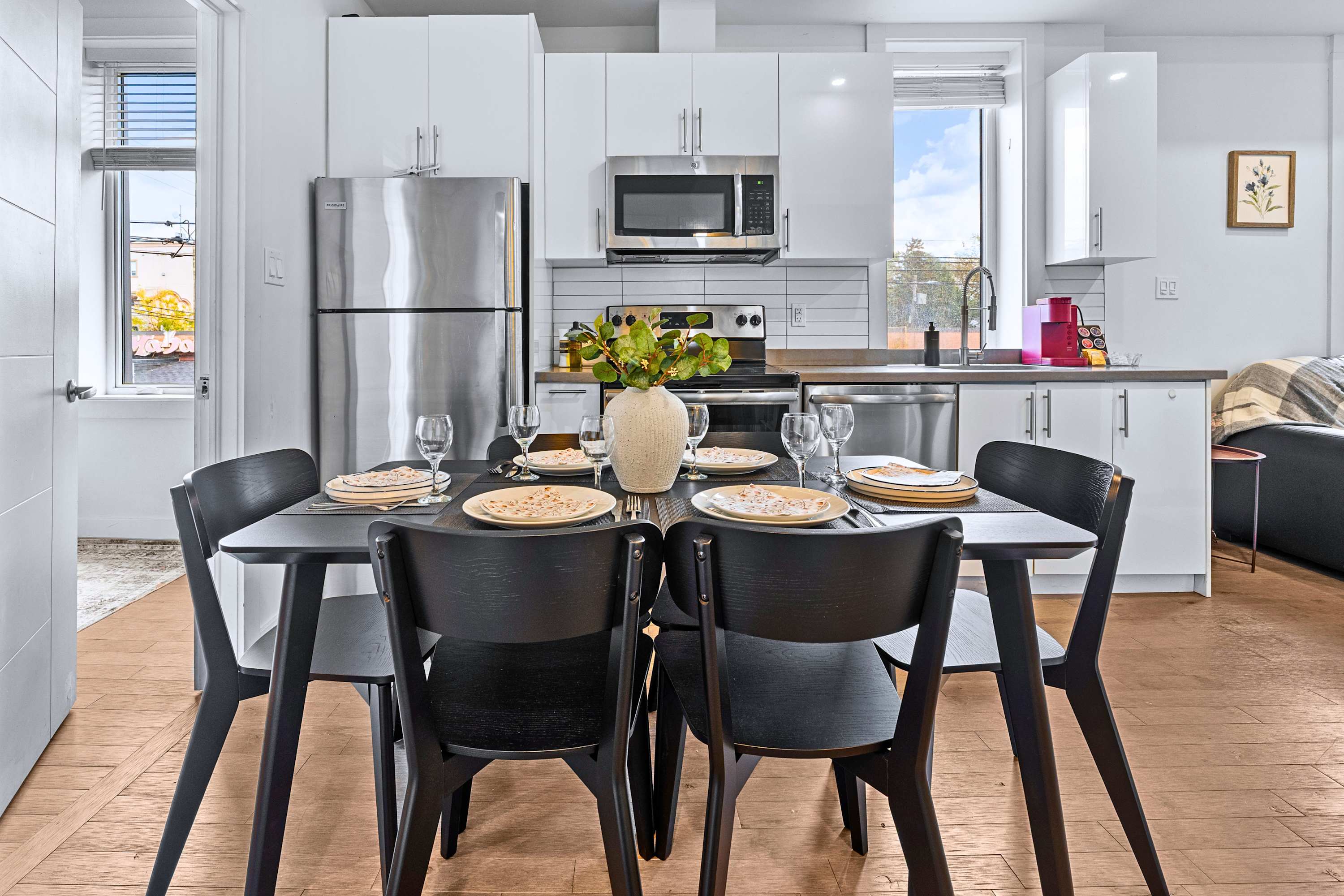 An inviting dining setup positioned right beside a sleek modern kitchen