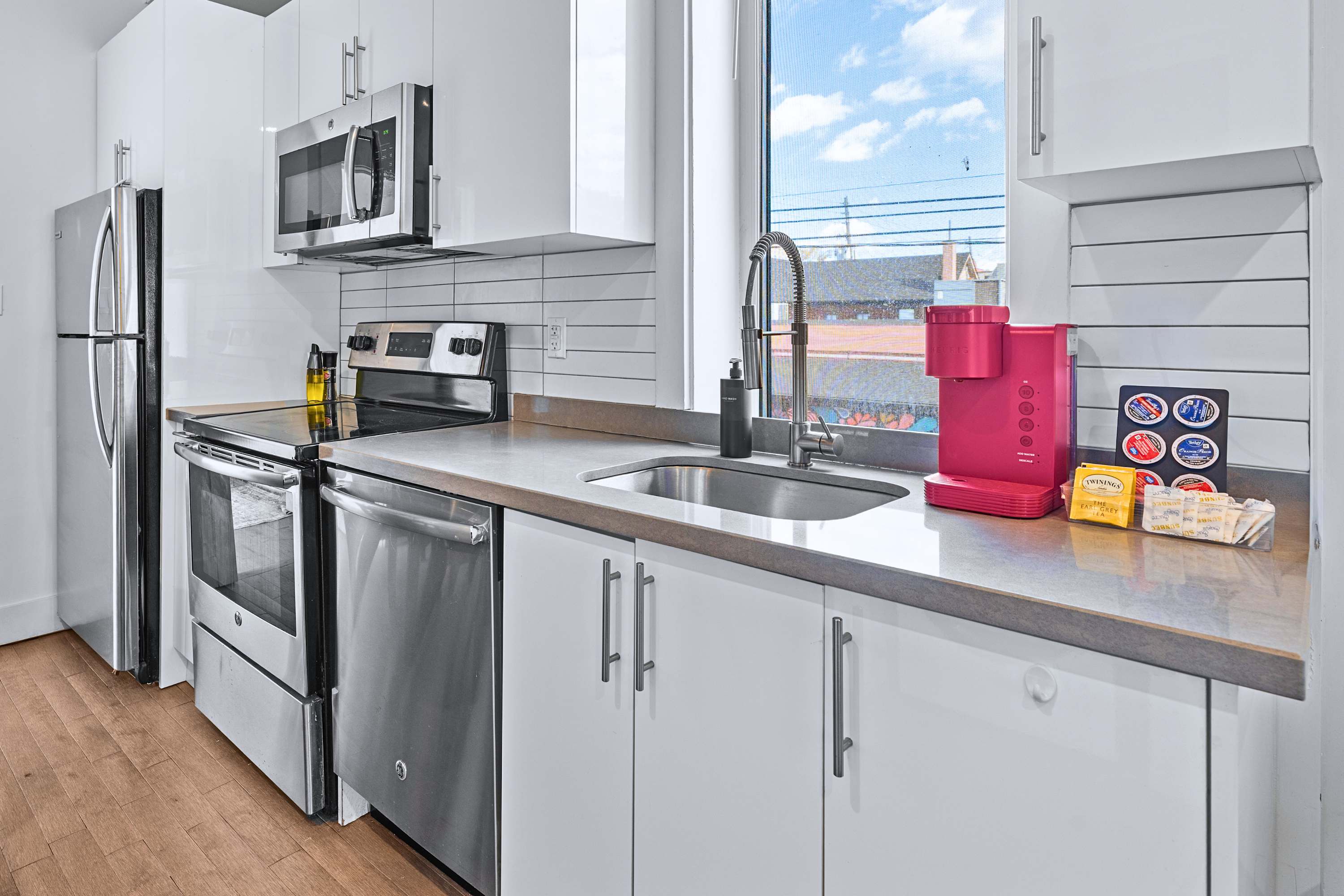 Functional kitchen counter space featuring clean backsplash and appliances