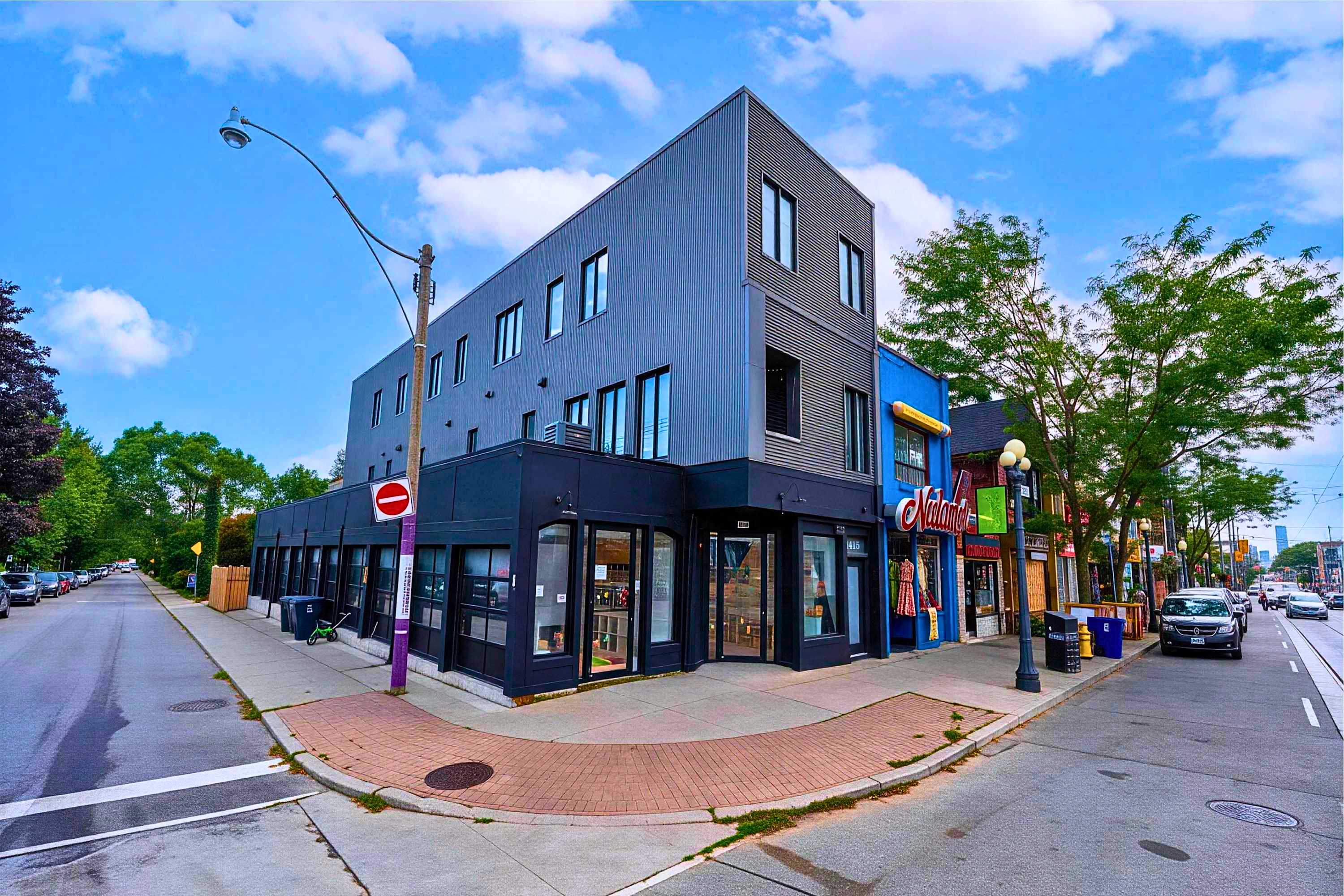 A modern urban building exterior situated along a charming city street