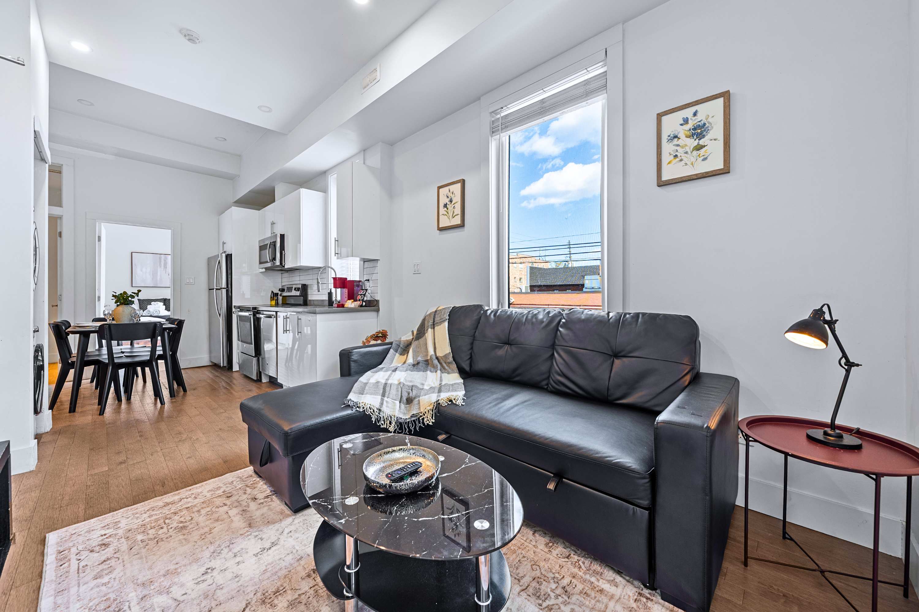Spacious open living room layout filled with natural light from large windows