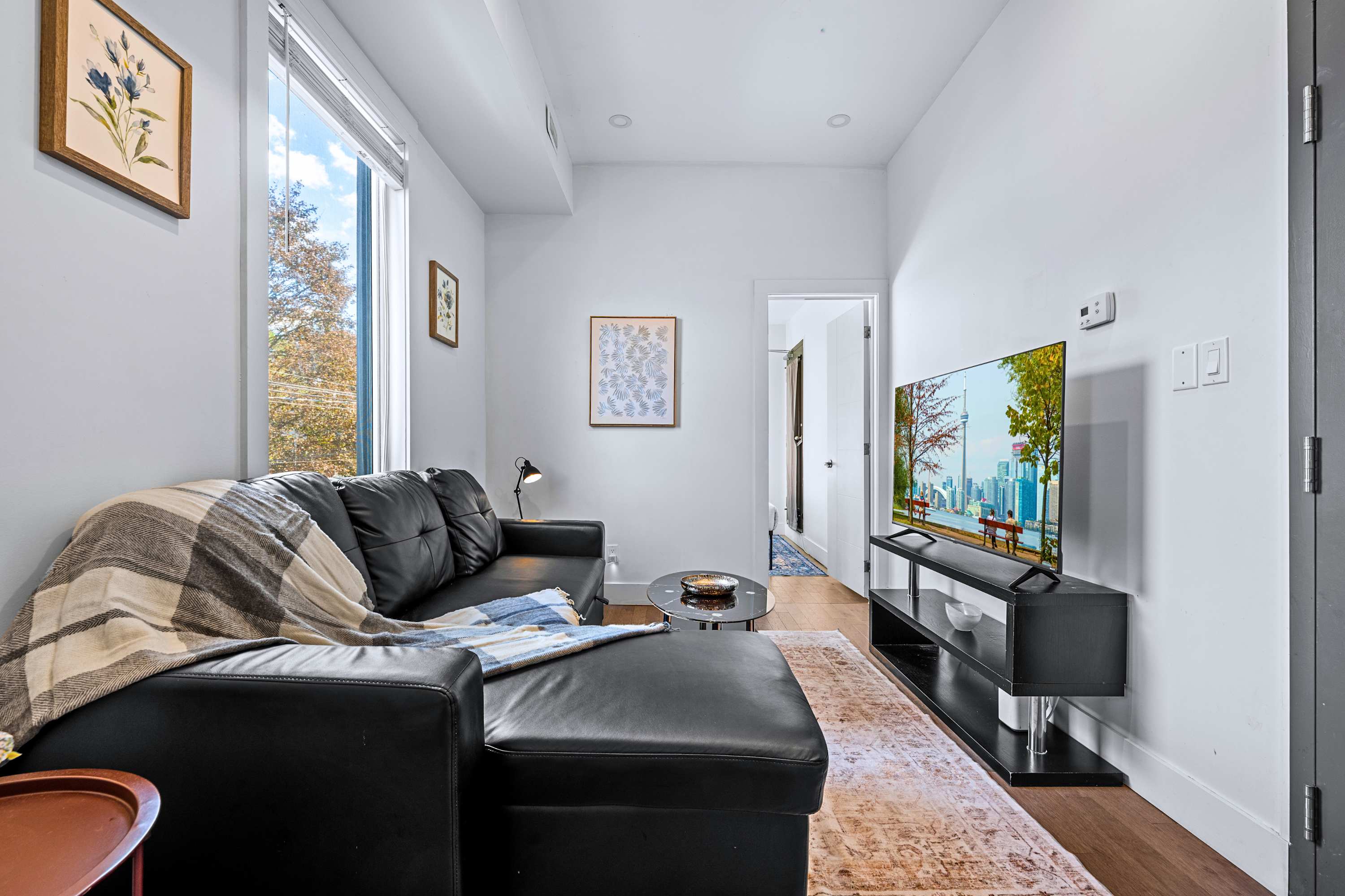 A relaxed sitting area complete with dark leather seating and contemporary decor