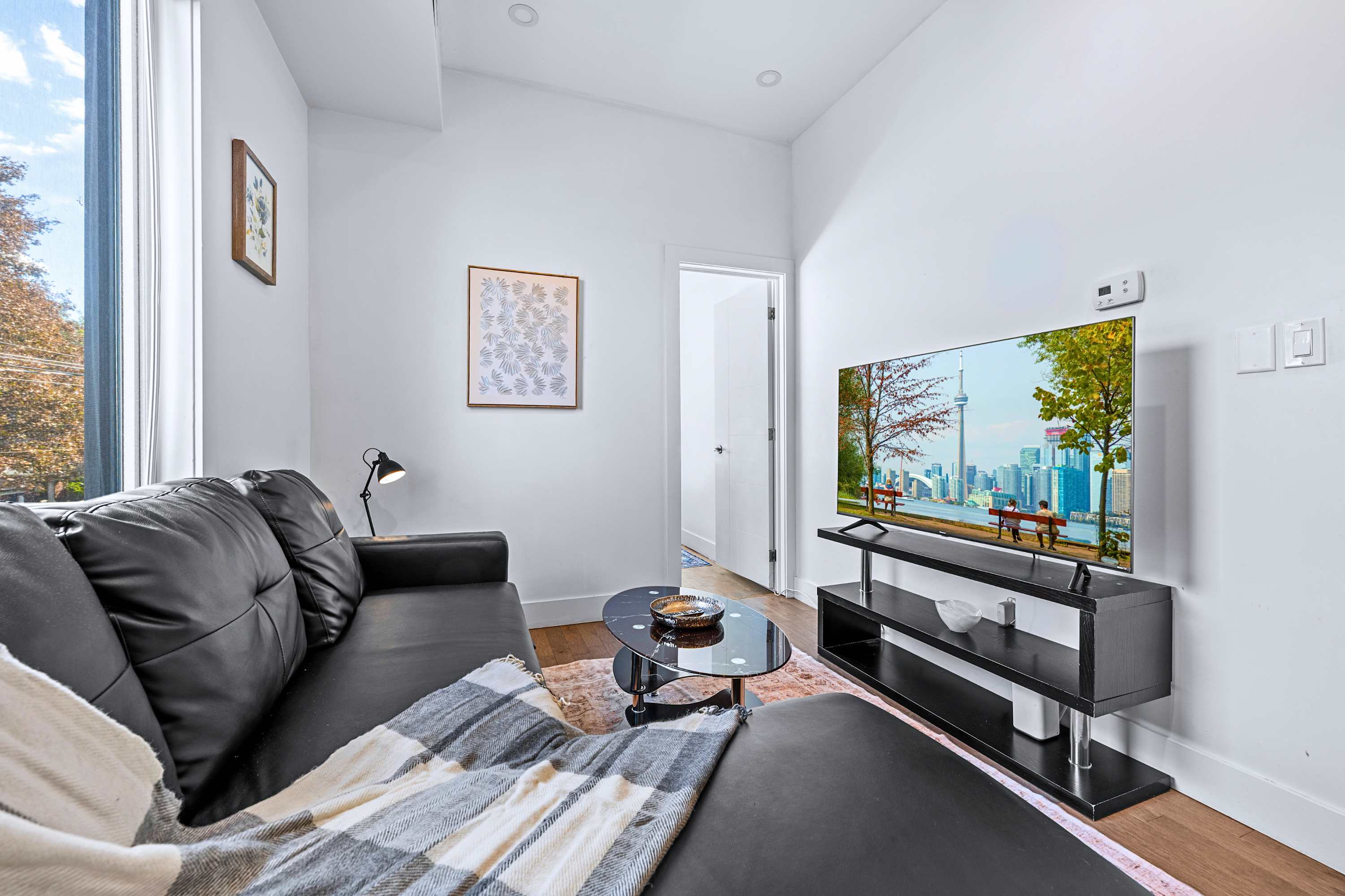 A serene interior setup combining comfortable lounge seating and media storage