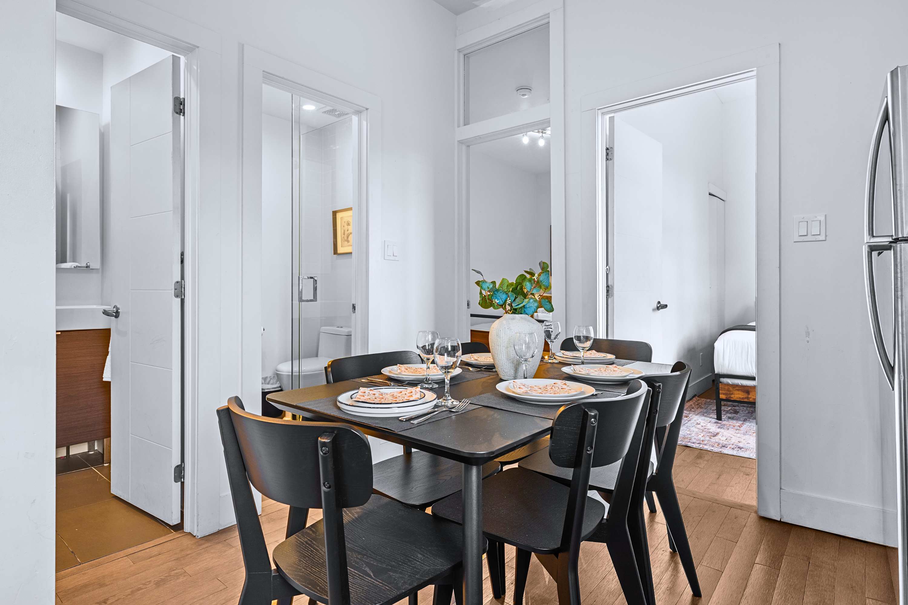 A central dining space arranged with a modern table set for group meals