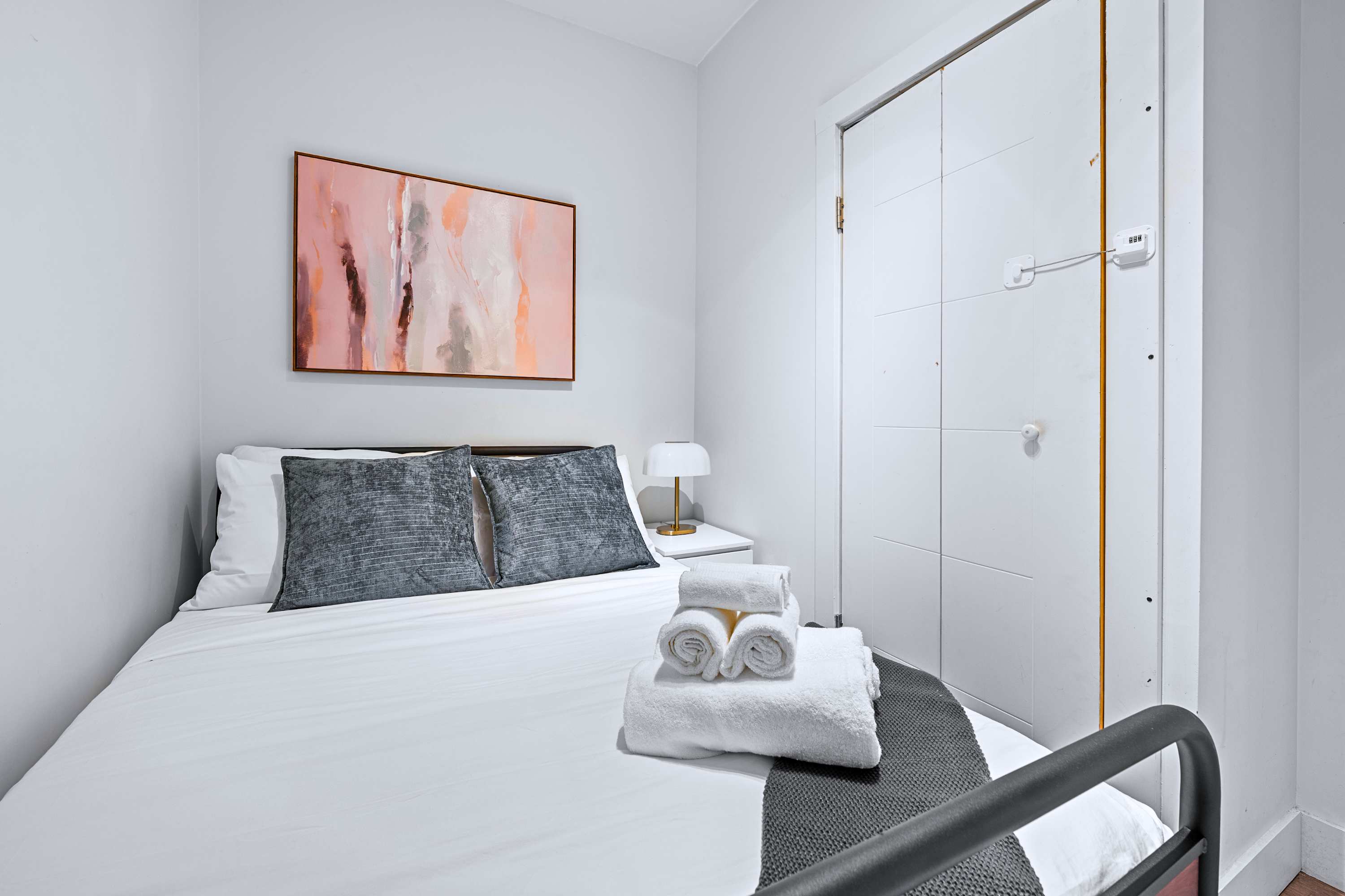 Restful guest room featuring a plush mattress and warm bedside lighting