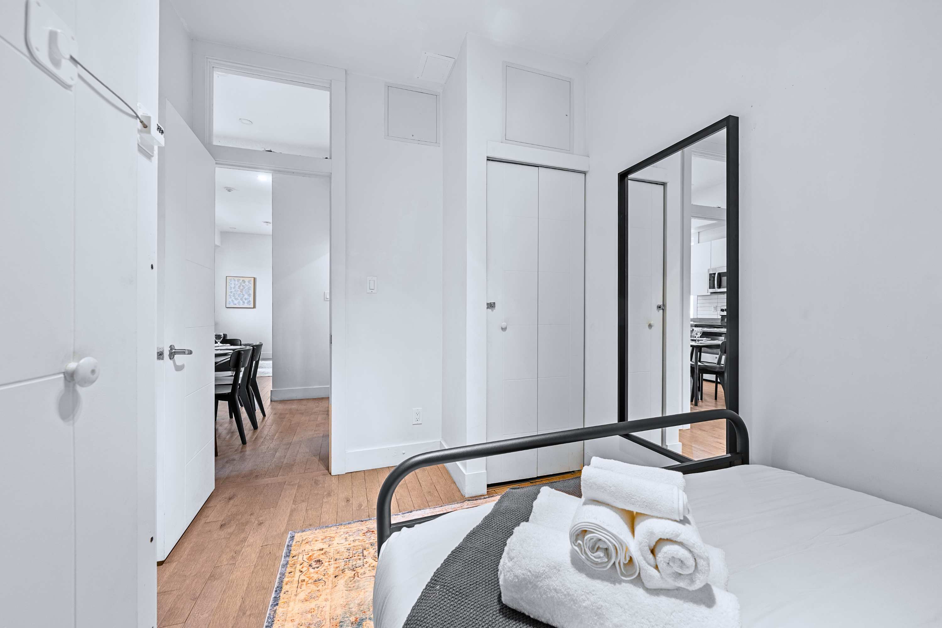 A calm guest bedroom styled with minimal decor and crisp white linens
