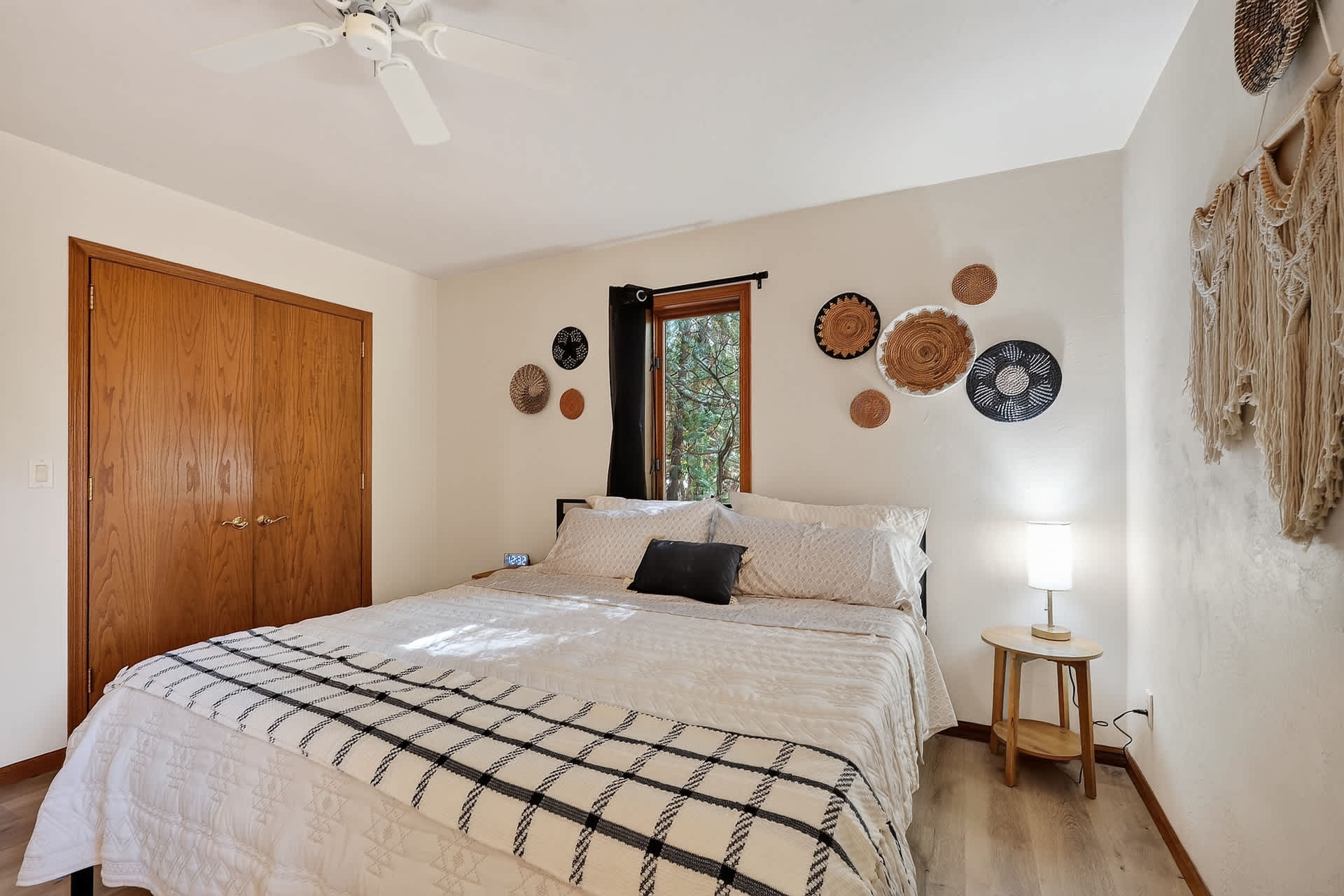 Bedroom 1: main floor king suite with ceiling fan and semi-private ensuite walk-in shower bathroom.