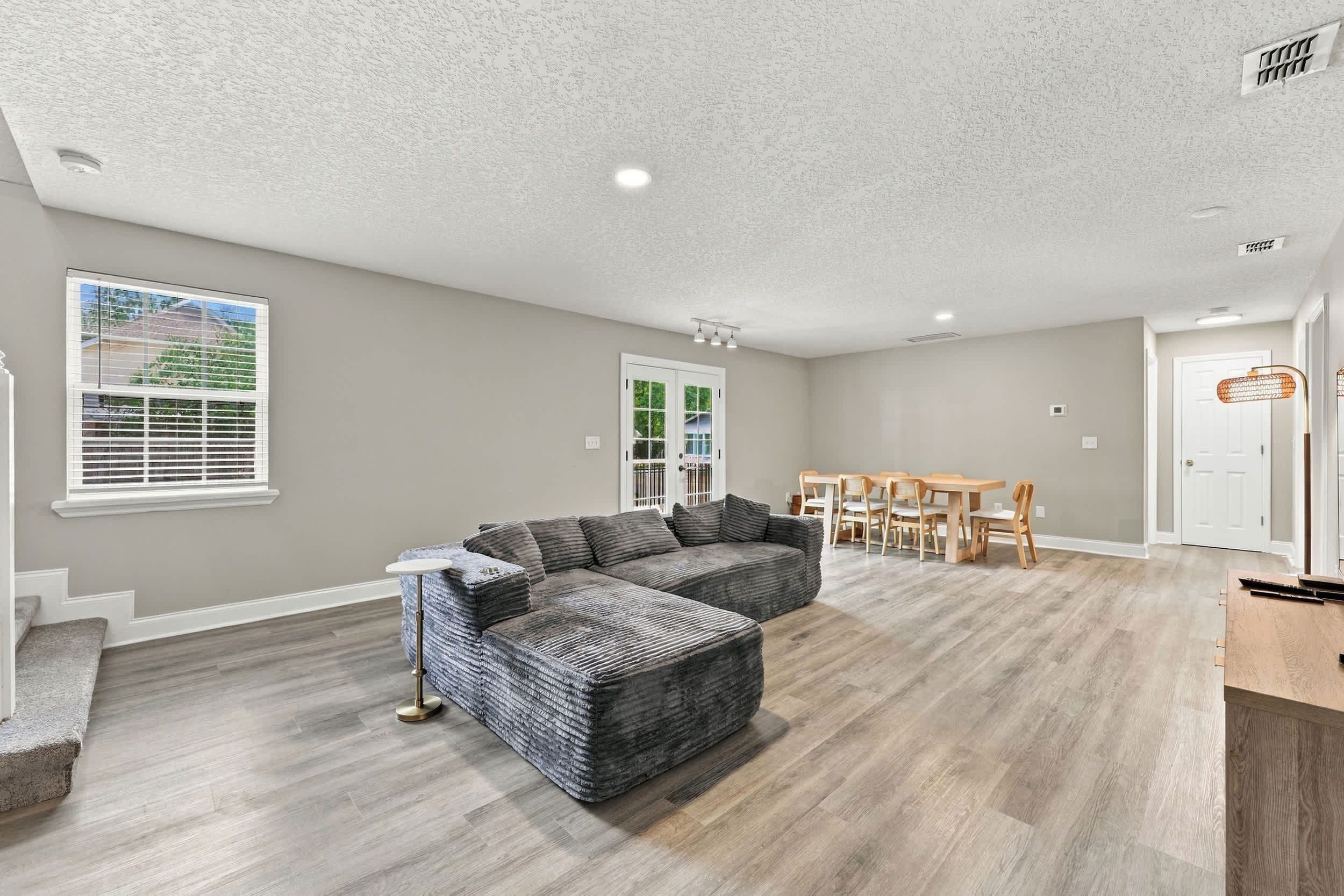 Gather and make memories in the spacious living room with a couch, Smart TV, and dining table​