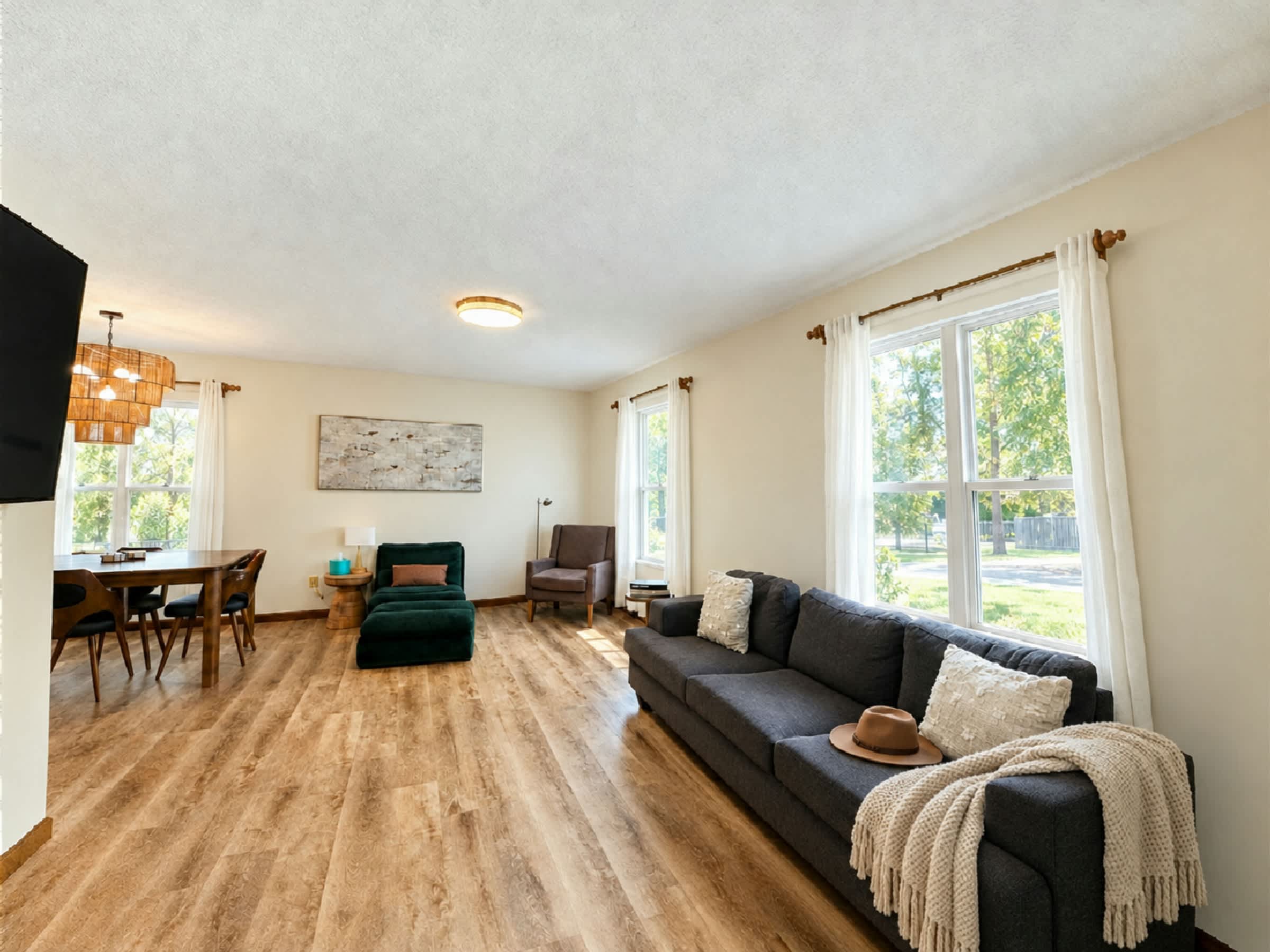Relax in this bright, comfortable living room featuring a cozy sofa, large windows, and inviting furnishings. The perfect place to unwind after enjoying Downtown Hamilton's dining, shopping, and entertainment.