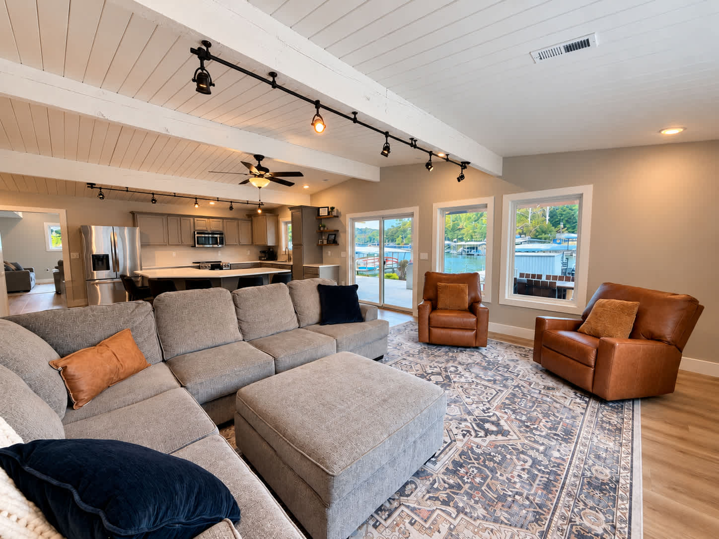 Unwind in the open living room with a comfortable sectional, Smart TV, and reclining chairs​