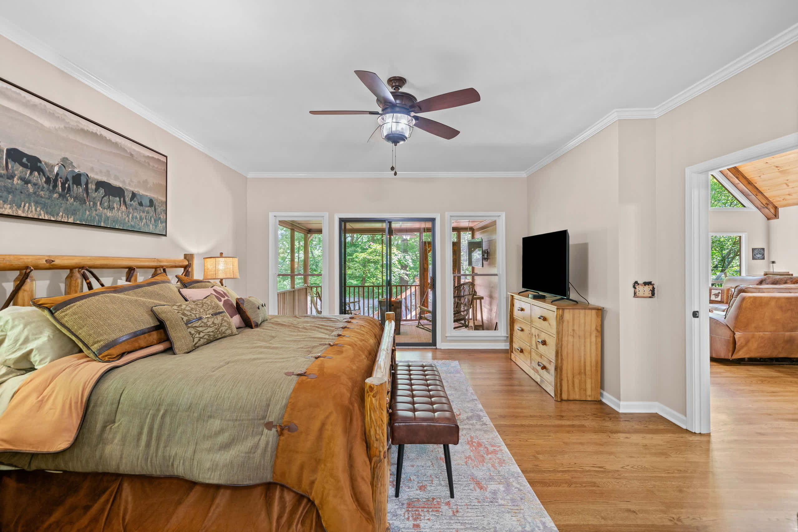 Relax in the spacious primary suite with a king bed, smart TV, private full bathroom, and screened-in balcony access​