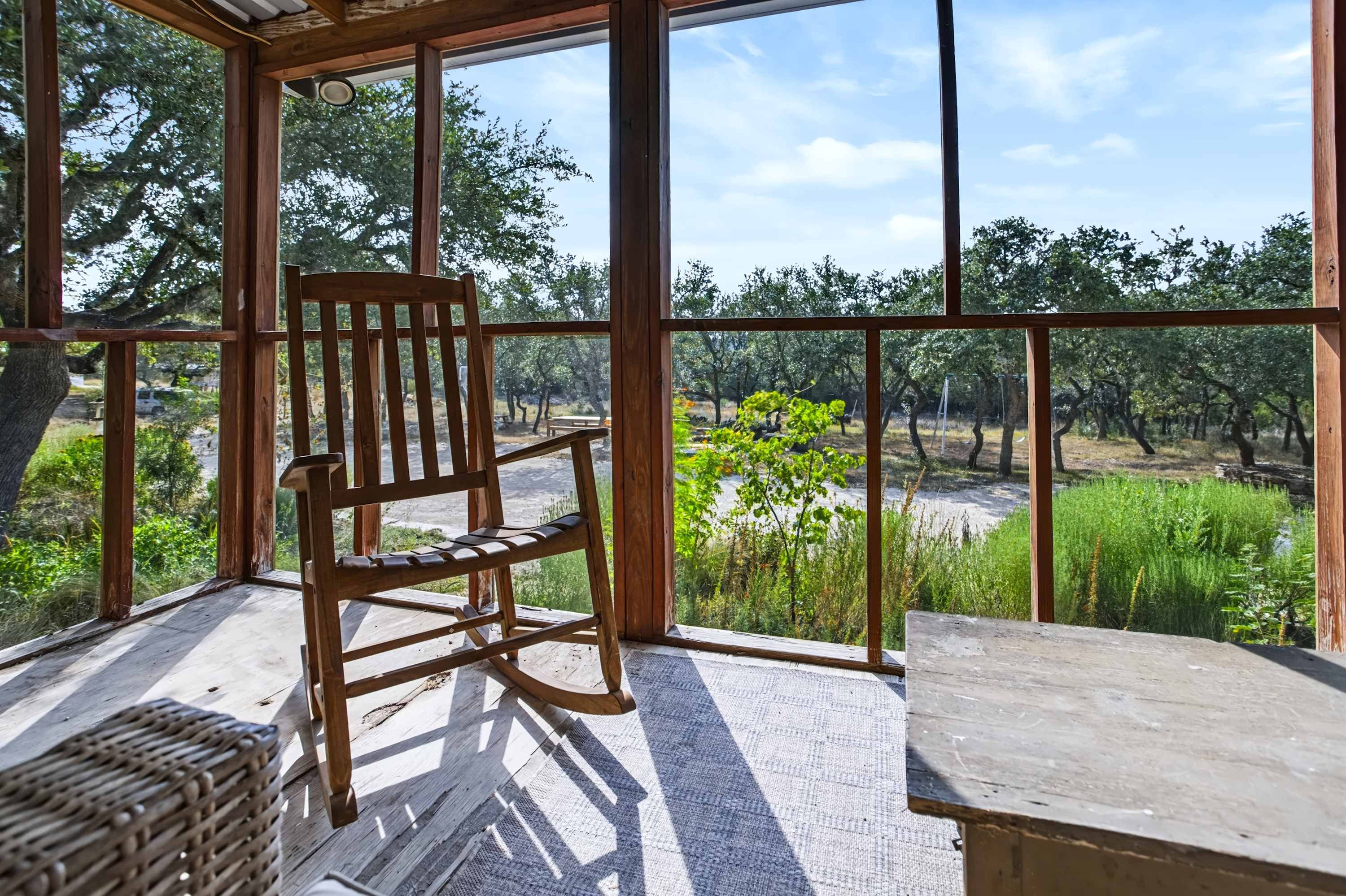 Take in the peaceful surroundings from the screened-in porch with outdoor seating