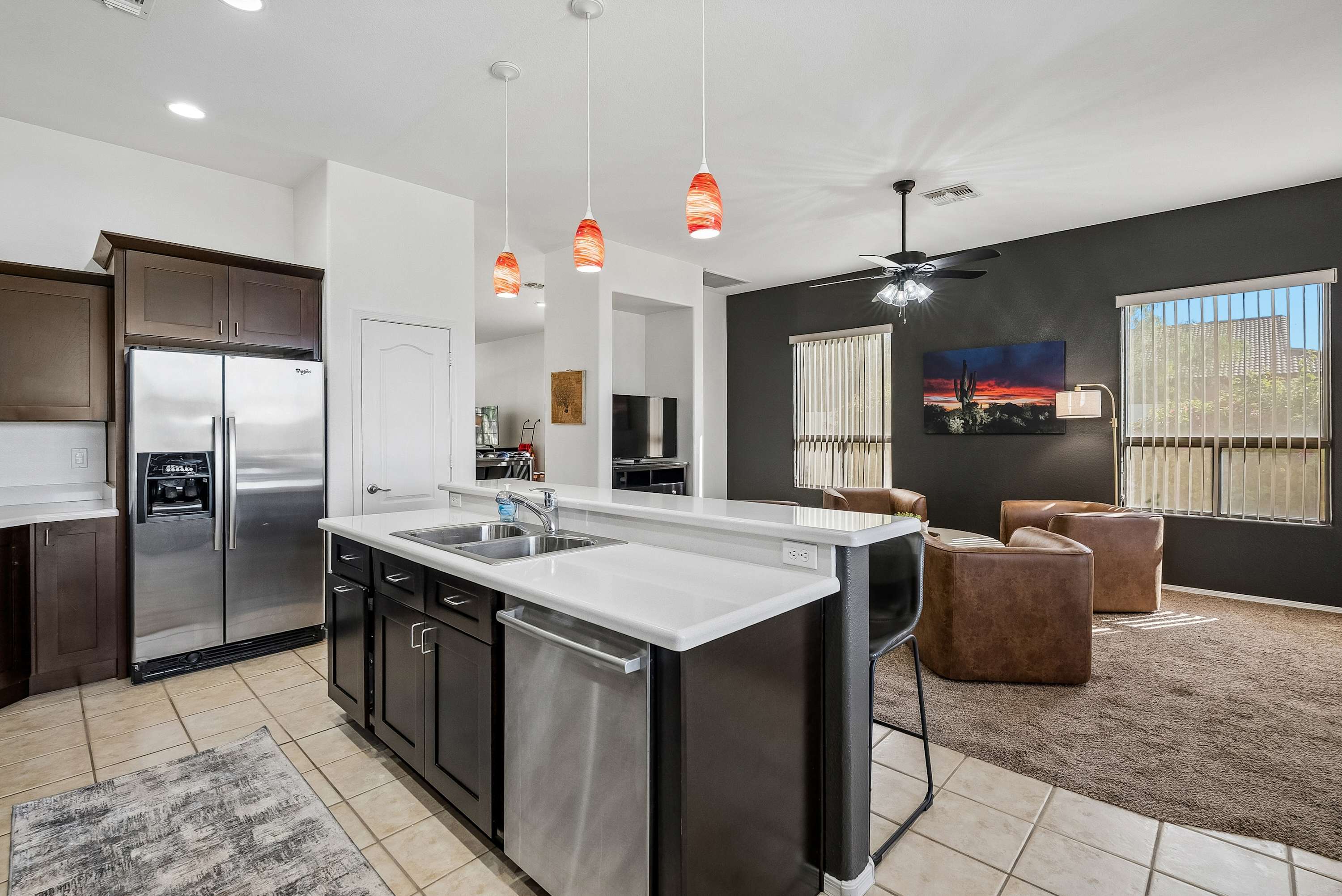 A spacious kitchen stocked with stay essentials and a welcoming bar area for 4 to dine and connect