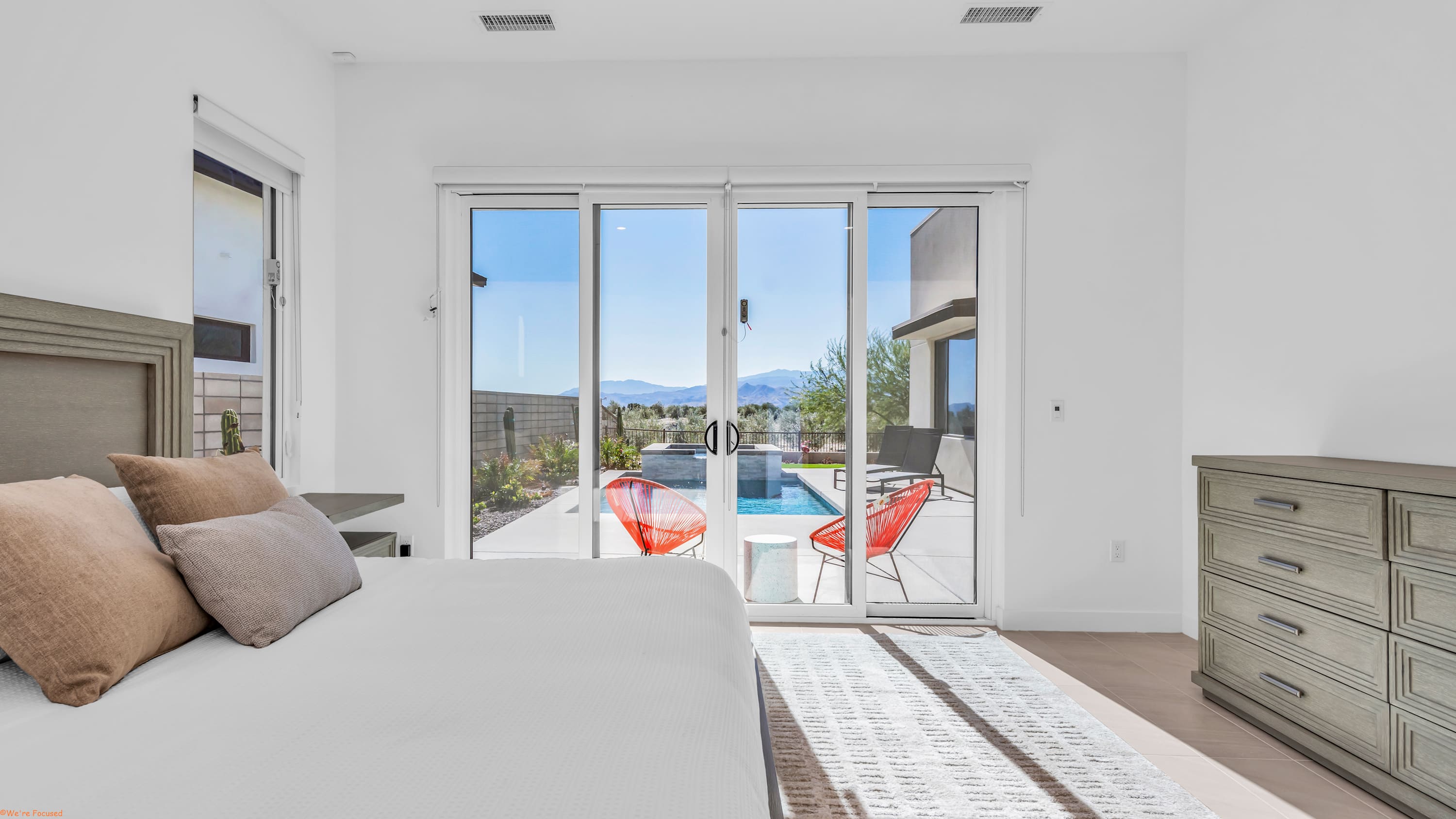 The primary king suite boasts a private ensuite & access to the patio​