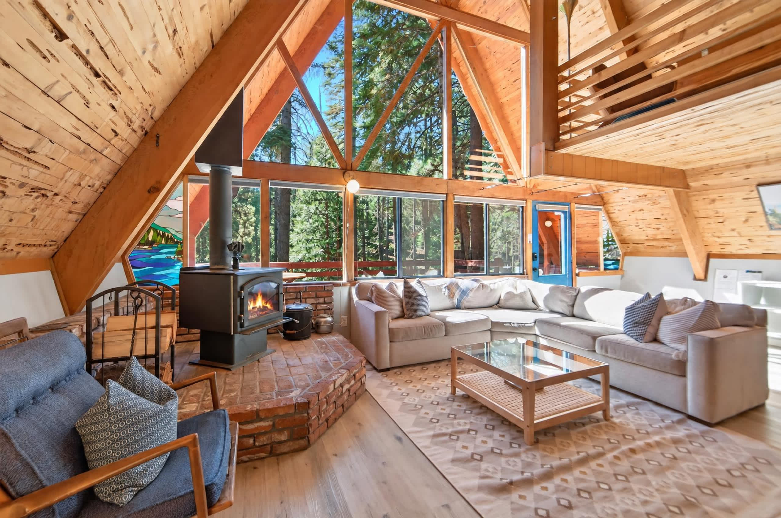 Settle into the bright, inviting cabin living room with a cozy couch, fireplace, and Smart TV for relaxing evenings after a day of adventure​