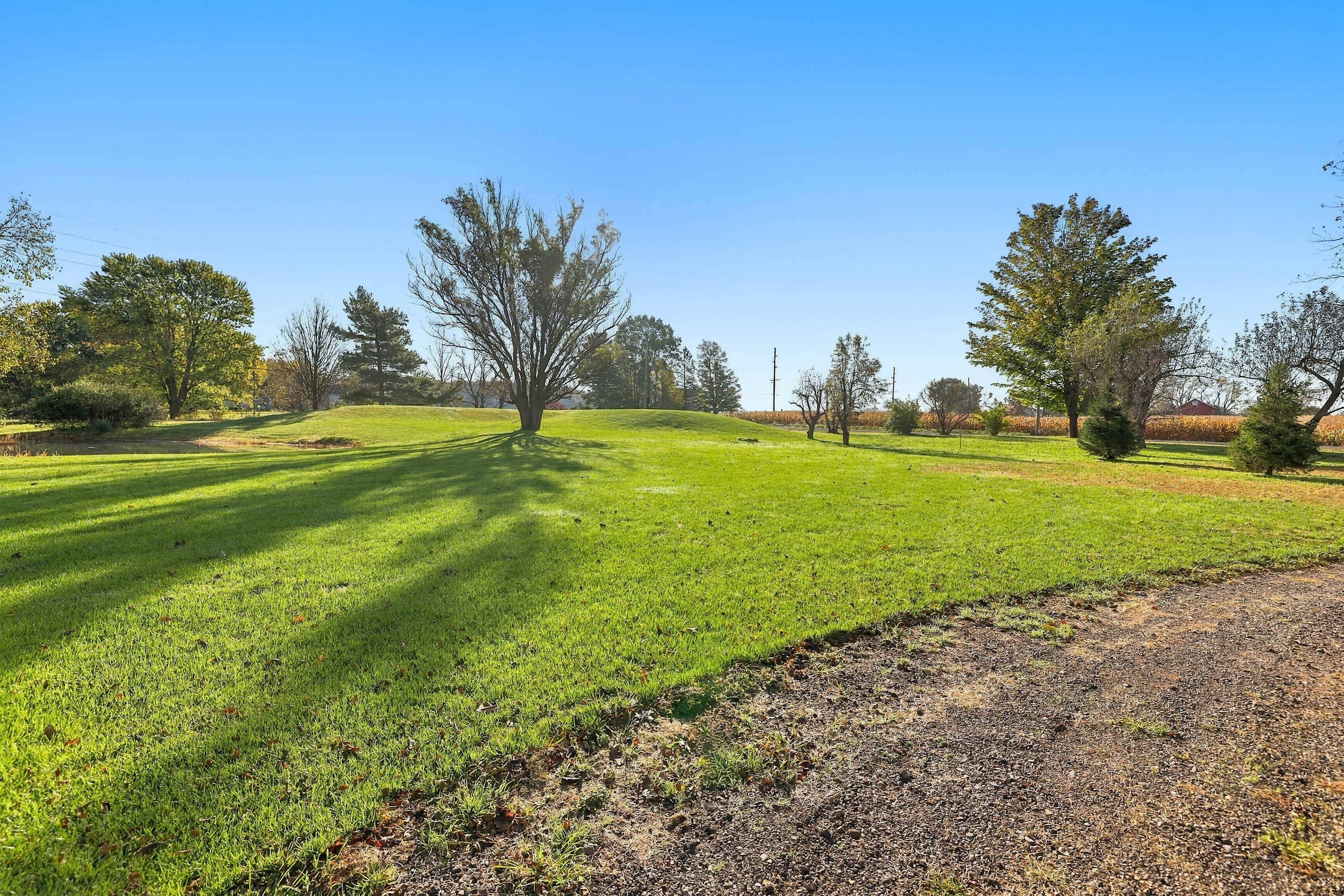 Pull up the drive to open lawn, a pond, and Michigan cornfields.