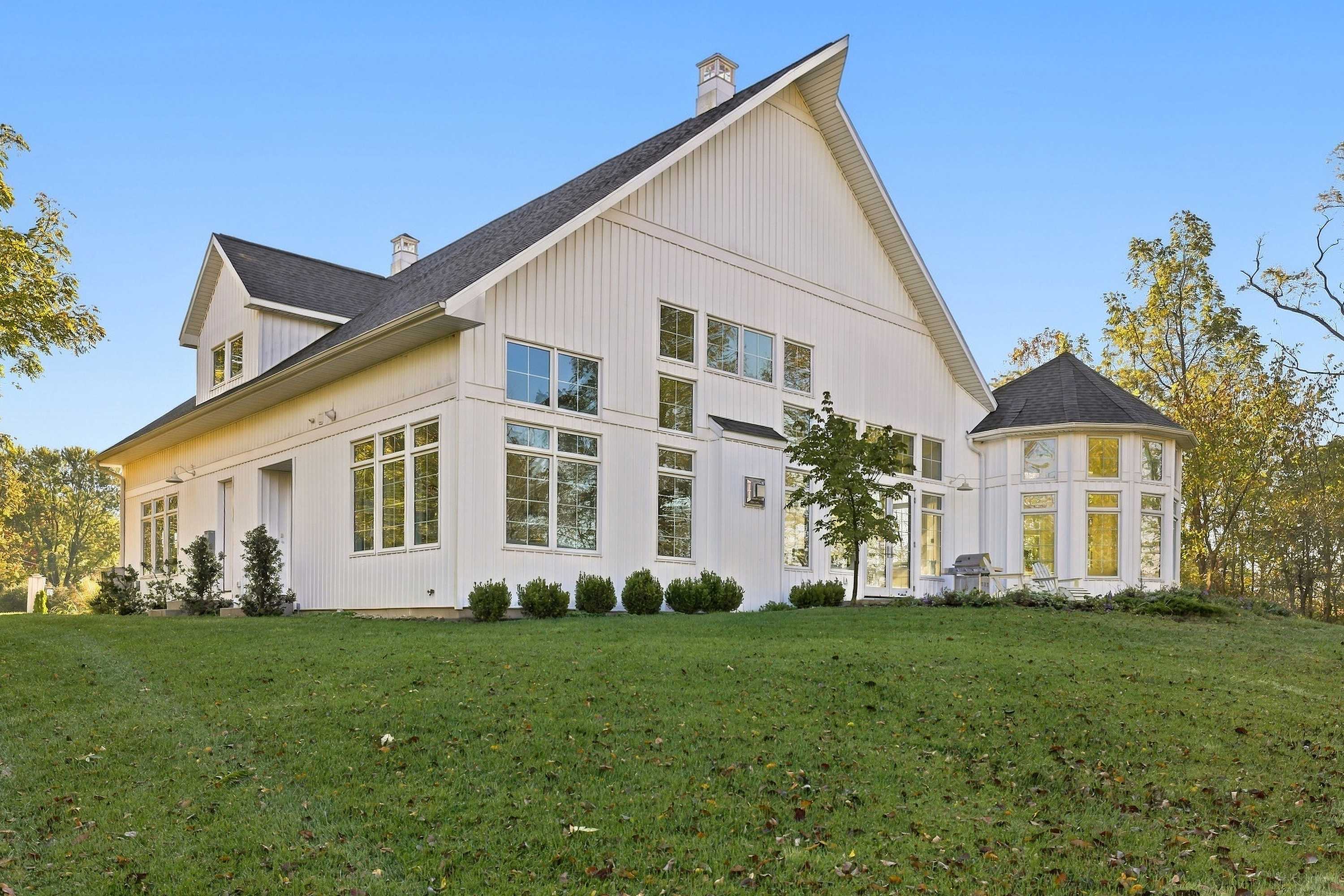 The Barn in Three Oaks, a soaring white retreat with its own turret.