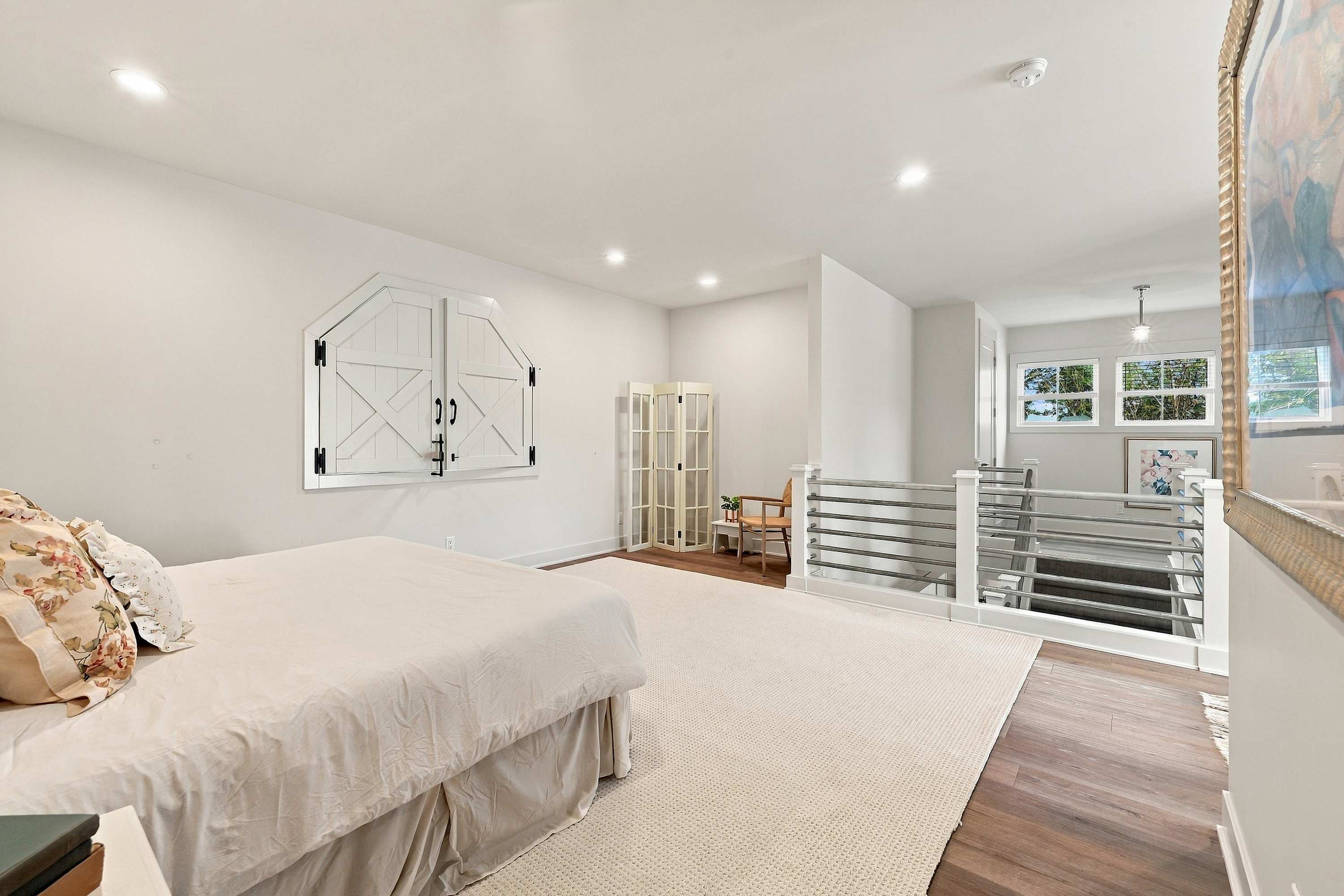 Upstairs family room with hayloft shutters over the great room.
