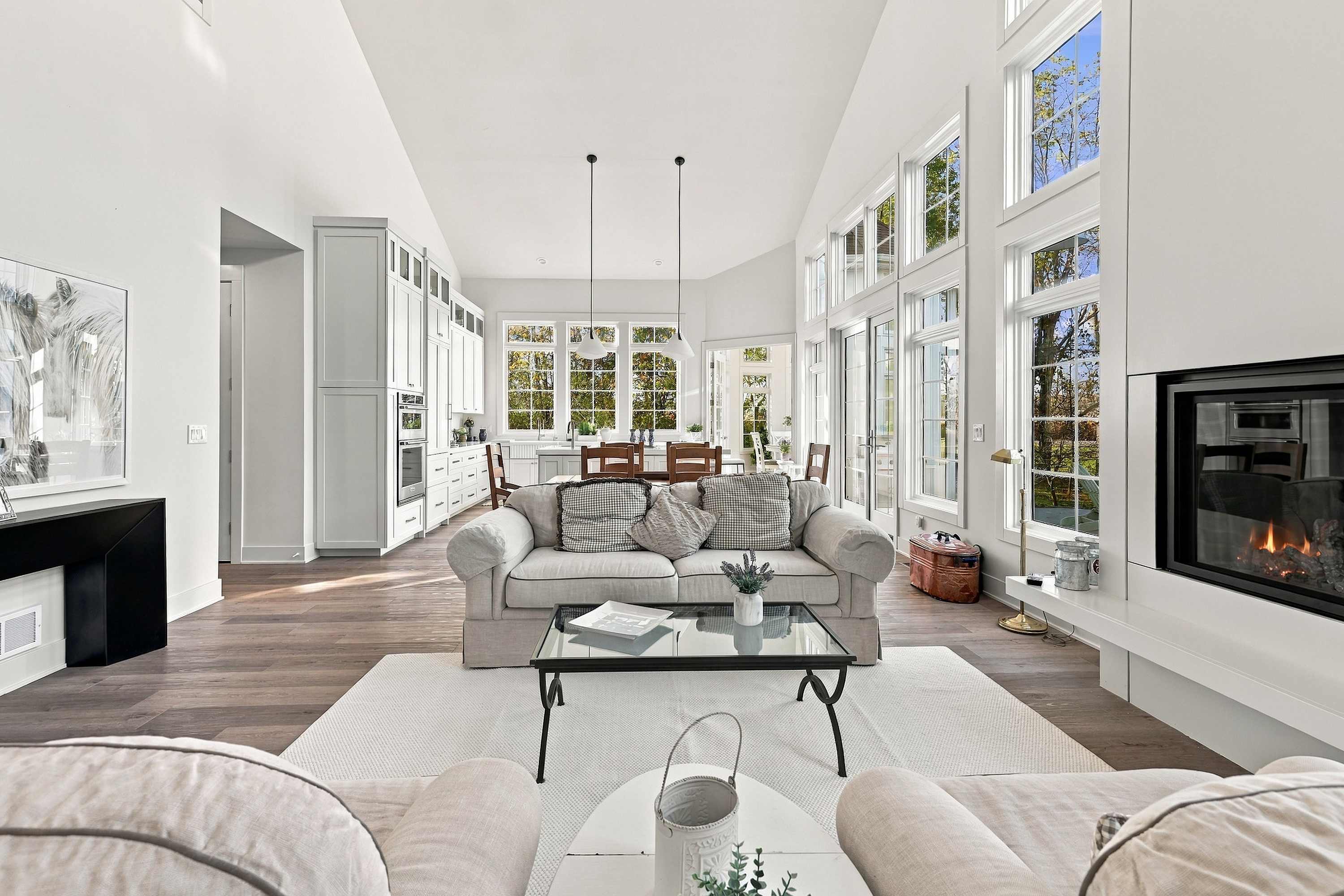 Open concept Harbor Country living with vaulted ceilings and a fireplace.