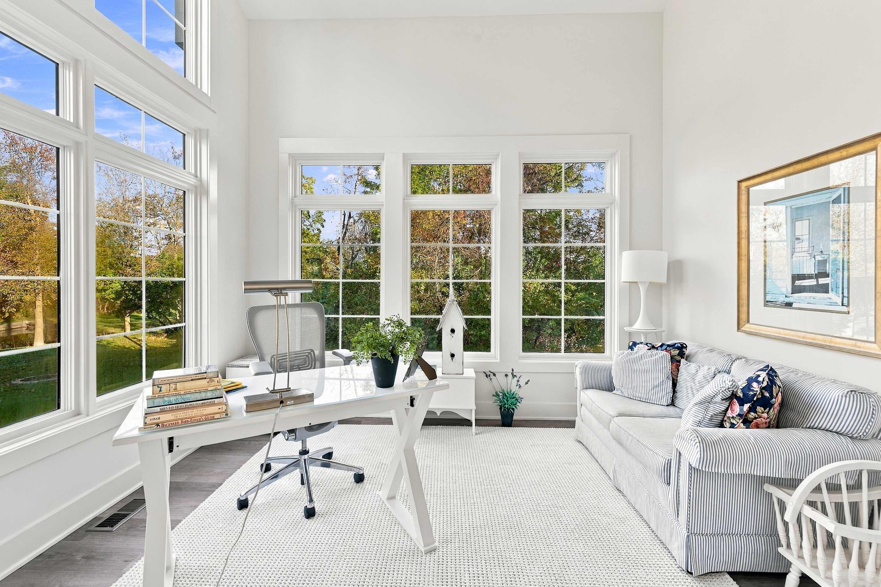 The Barn's home office with an ergonomic chair and pond views.