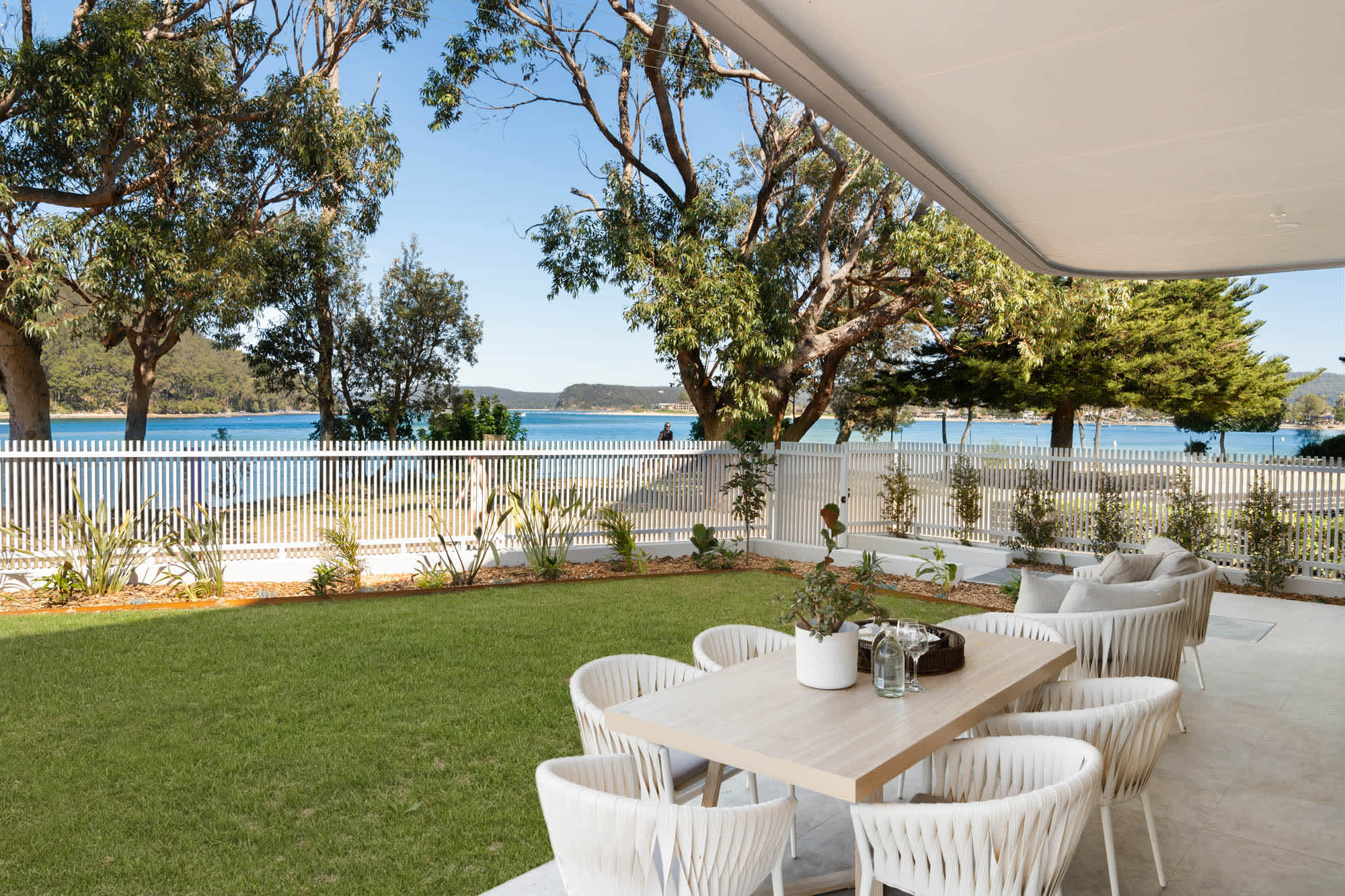 Anna Athina is a brand-new, beachfront three-bedroom apartment in Ettalong Beach sleeping up to 6, with a garden gate that opens straight onto the sand. Enjoy water views through the gums, a private lawn and covered alfresco dining, a stone-island kitchen, three queen bedrooms, two designer bathrooms including a freestanding bath, a lap pool, and an easy walk to Ettalong’s cafés, restaurants and the Palm Beach ferry.